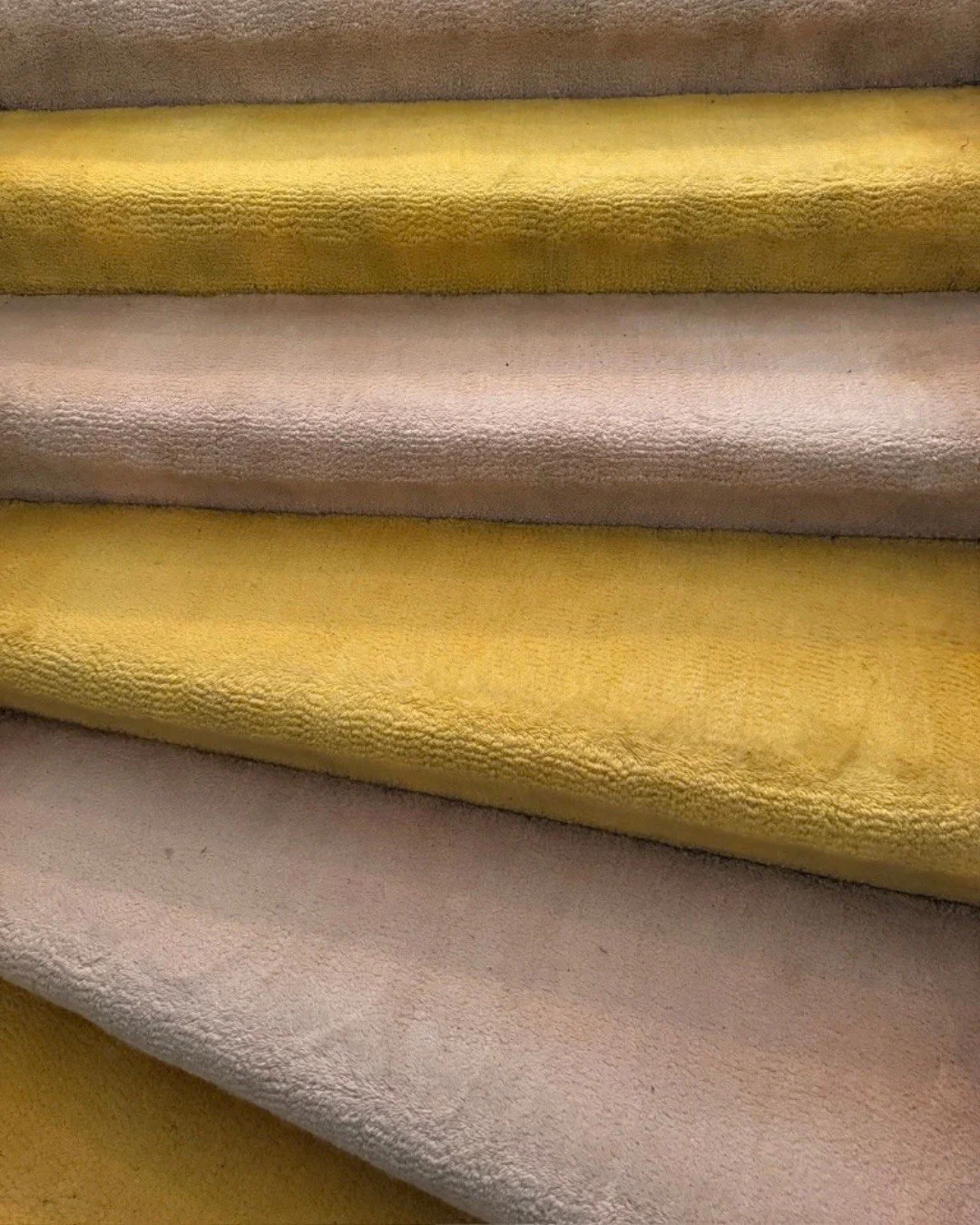 Mustard and blush upholstery fabrics draped in soft folds