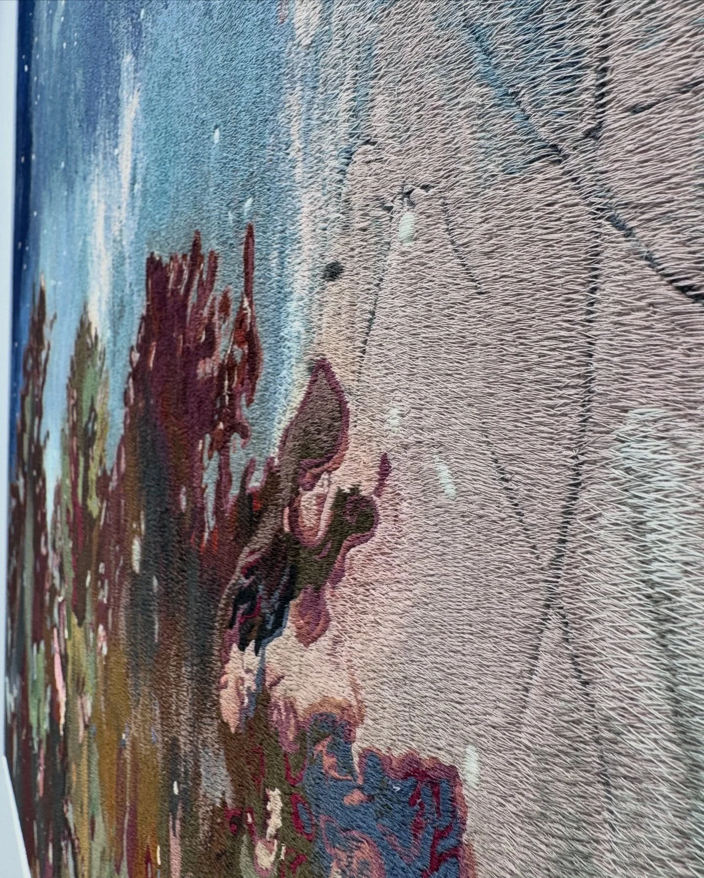 Close-up of layered stitches and texture in a fiber artwork