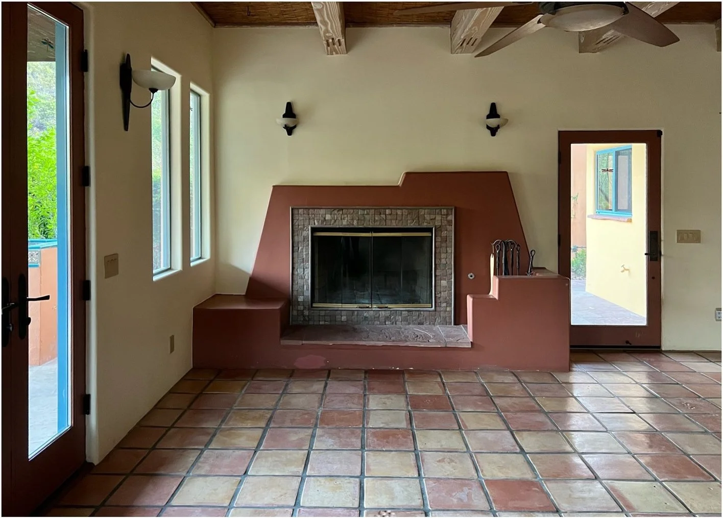 Original living room with terracotta fireplace surround and Saltillo floor