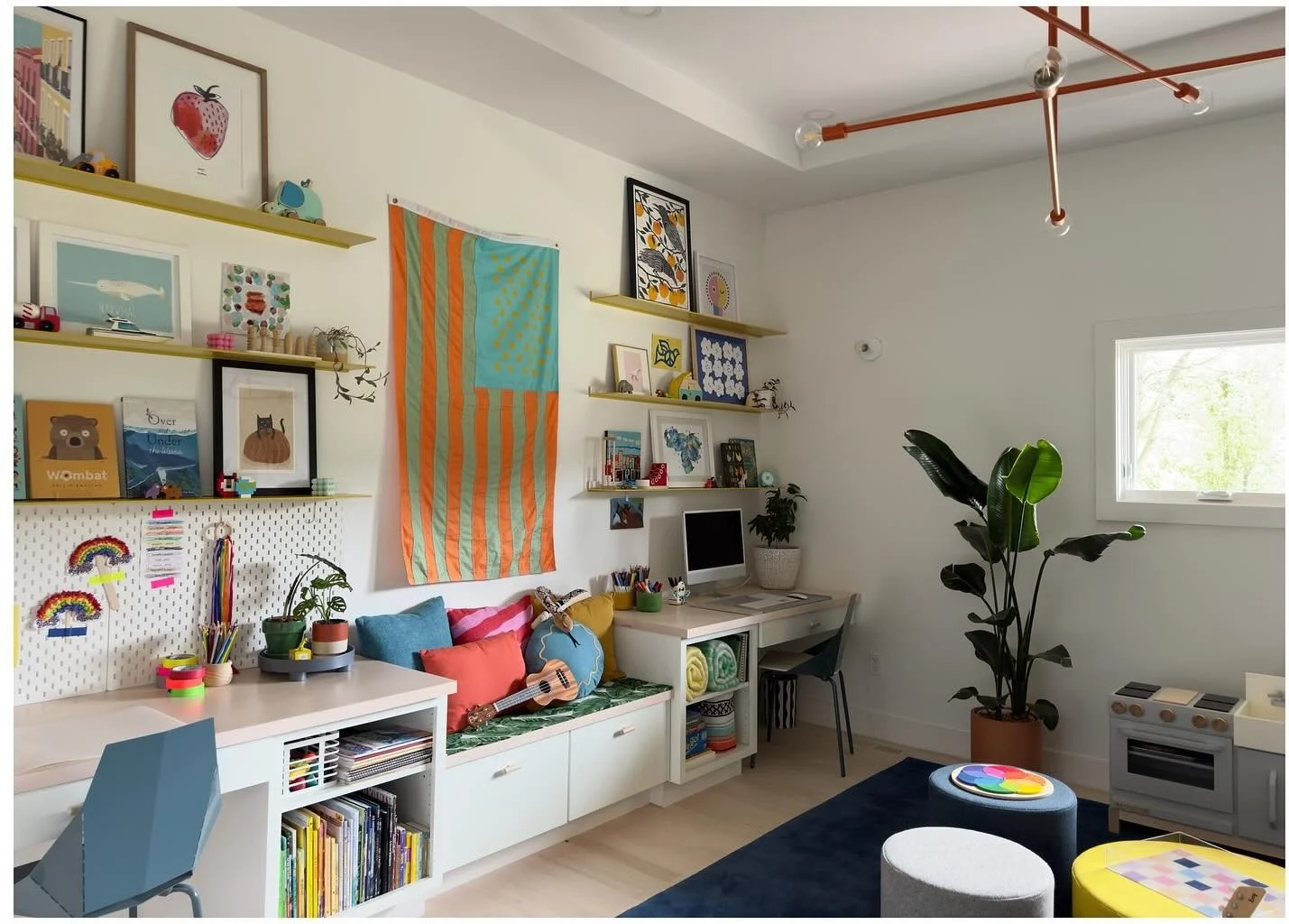 Bright playroom with desk gallery wall and built-in storage