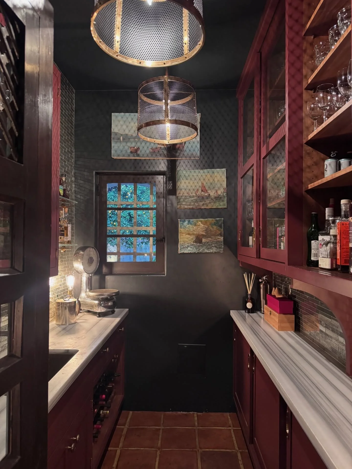 Dark red bar with patterned tile and circular brass pendants