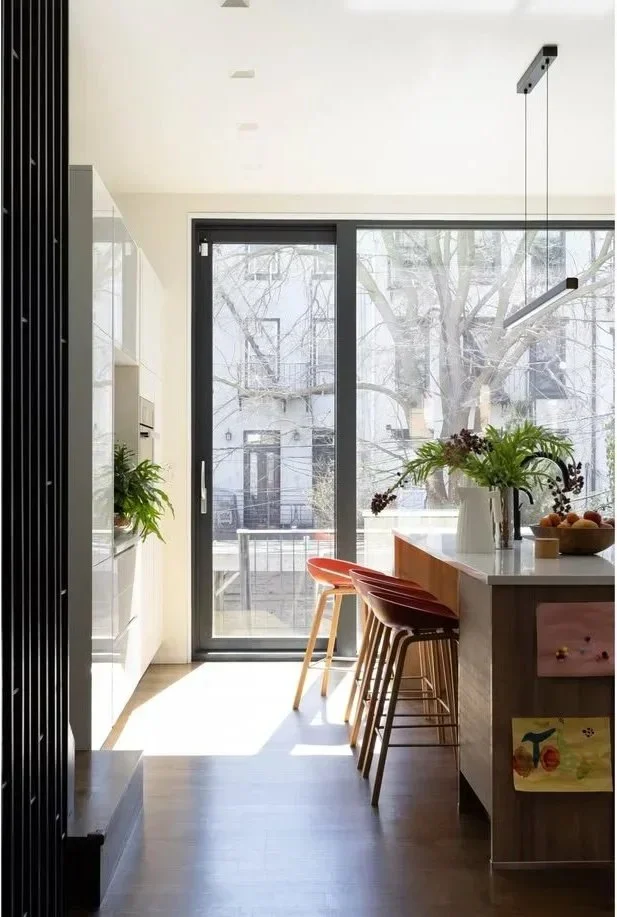  No Sleep Till Brooklyn ↗  A wood kitchen island opens toward the garden.