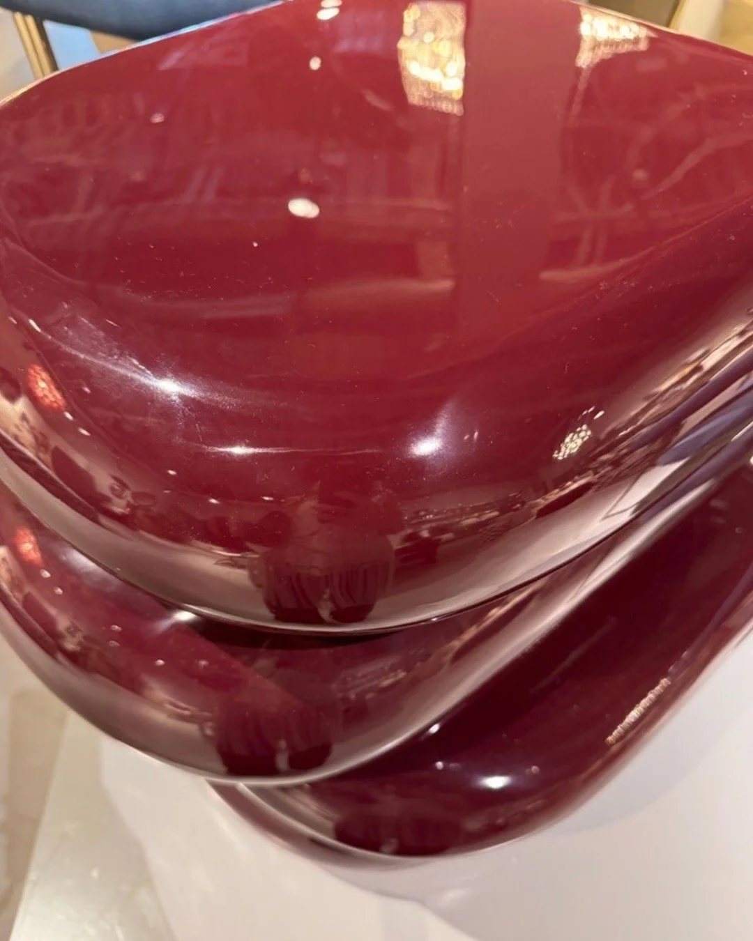 Close-up of glossy red curved ceramic vessels