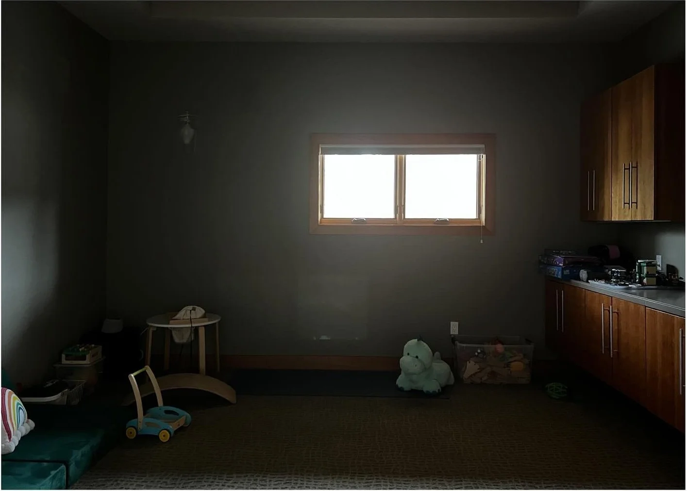 Dark room before renovation with small high windows