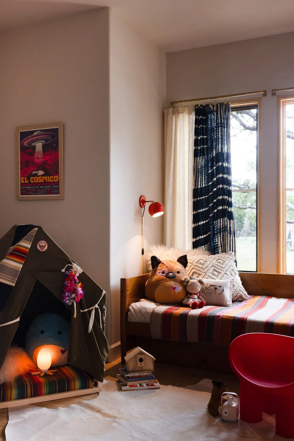 Child’s room with a striped window seat and a small play tent.