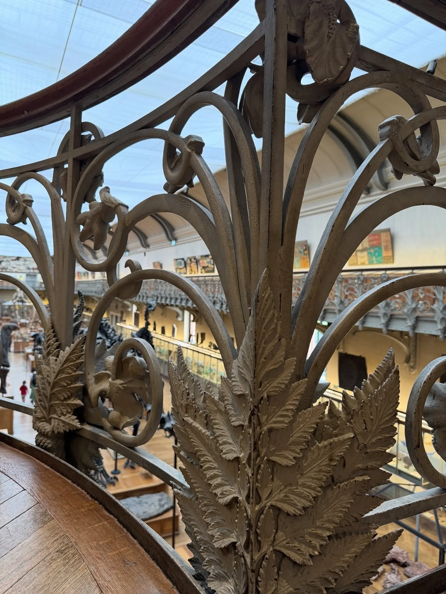 Close-up of decorative iron railing with botanical scrollwork