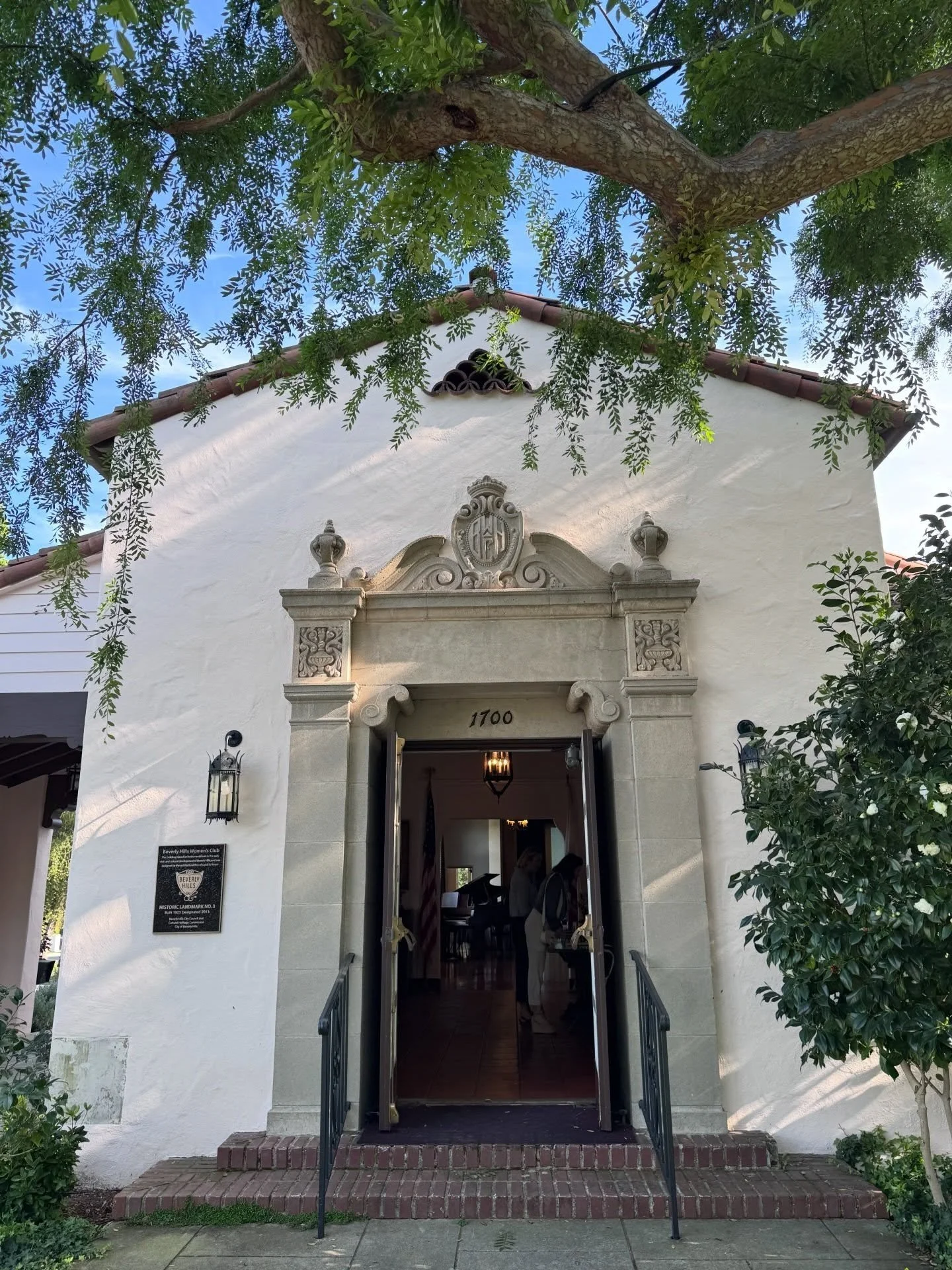 Historic white entrance with an ornate carved stone surround