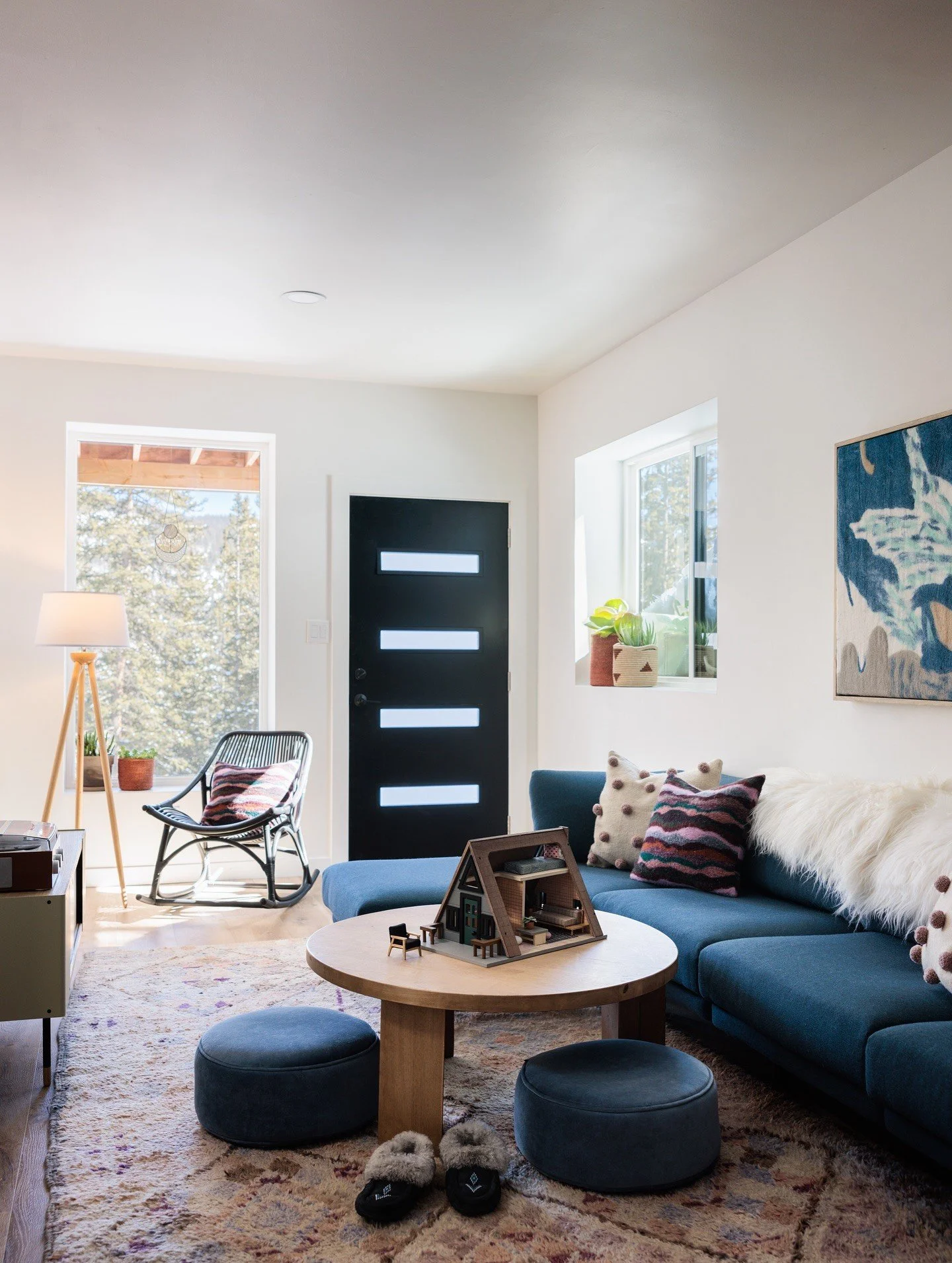 Small living room with a blue sofa and round coffee table