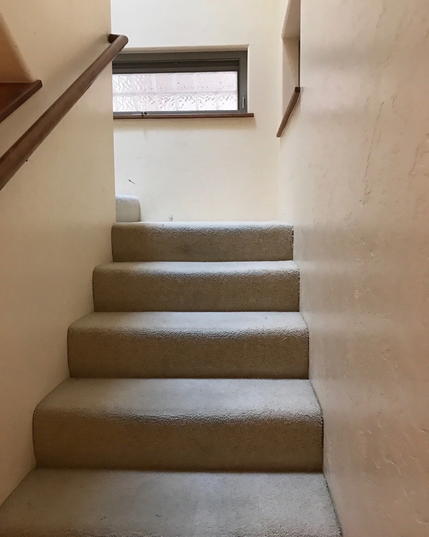 Carpeted staircase before replacement with wood flooring
