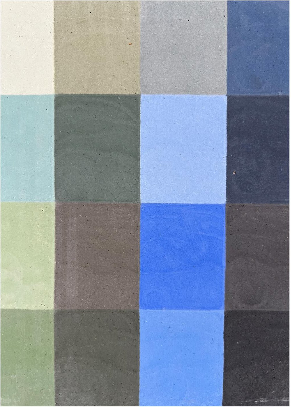 Close view of a tile sample with blue green and gray color blocks