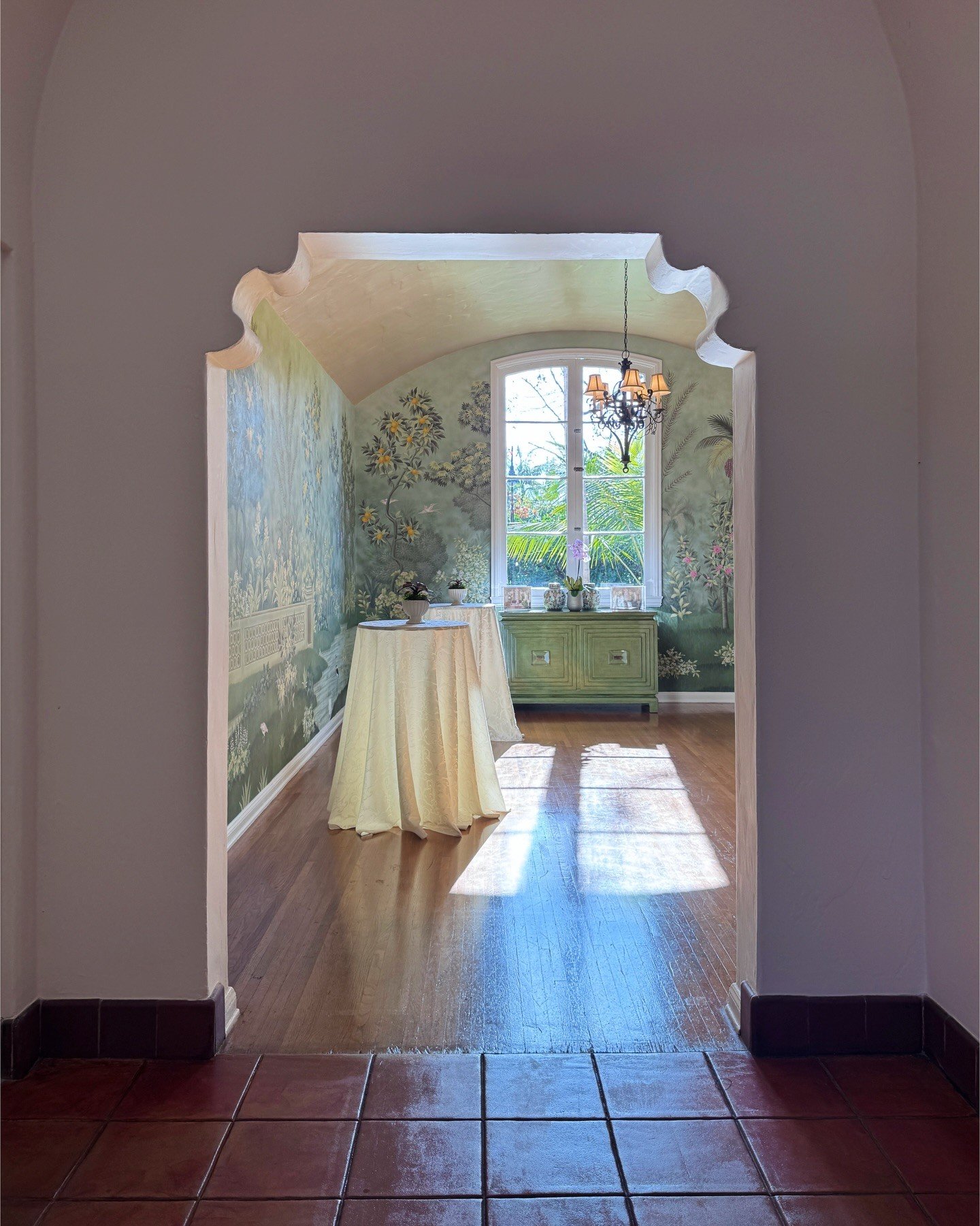 Arched interior doorway opening toward a bright window