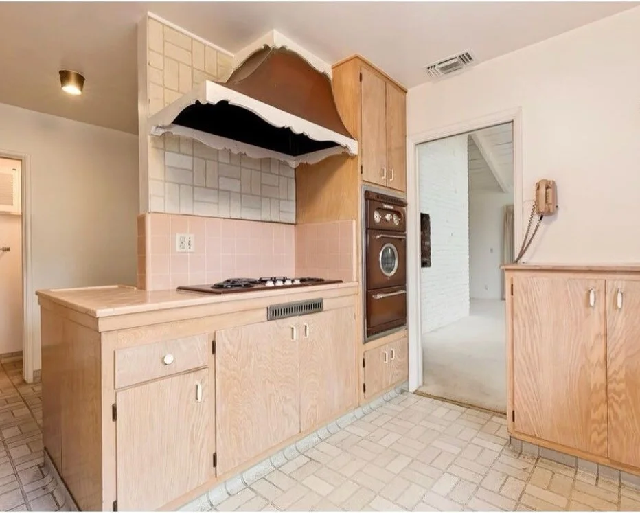 Kitchen demolition exposing a removed wall and range area