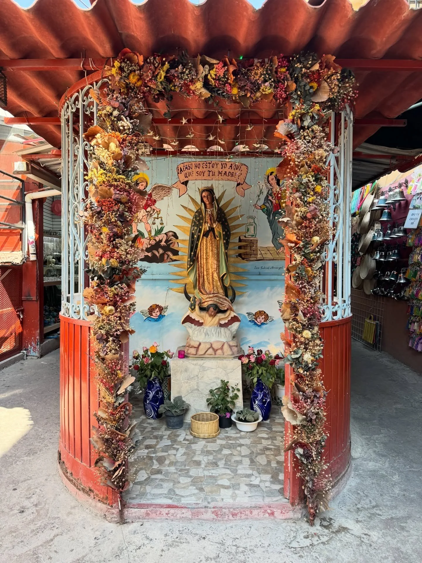 Colorful decorated shrine with flowers and ceramic objects