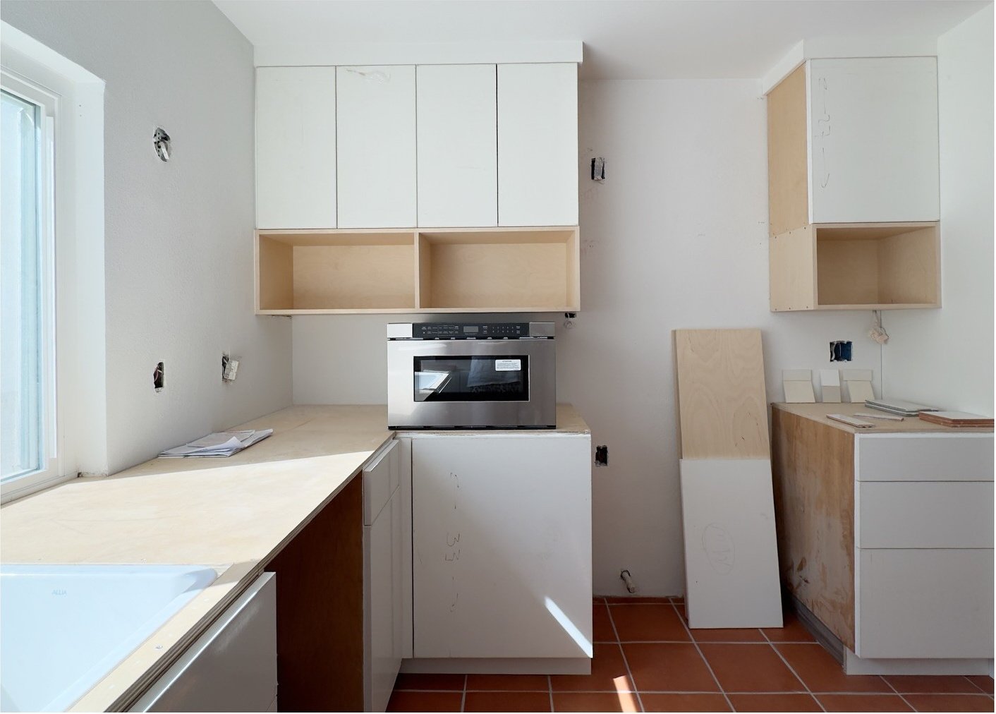 Original kitchen cupboards and tiled counters before renovation