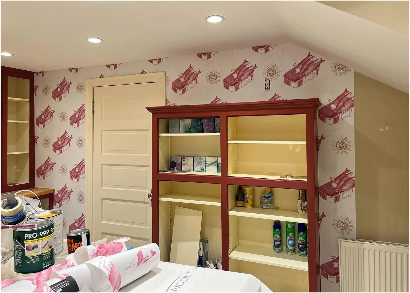 Open burgundy storage cabinet with pale green interior shelves
