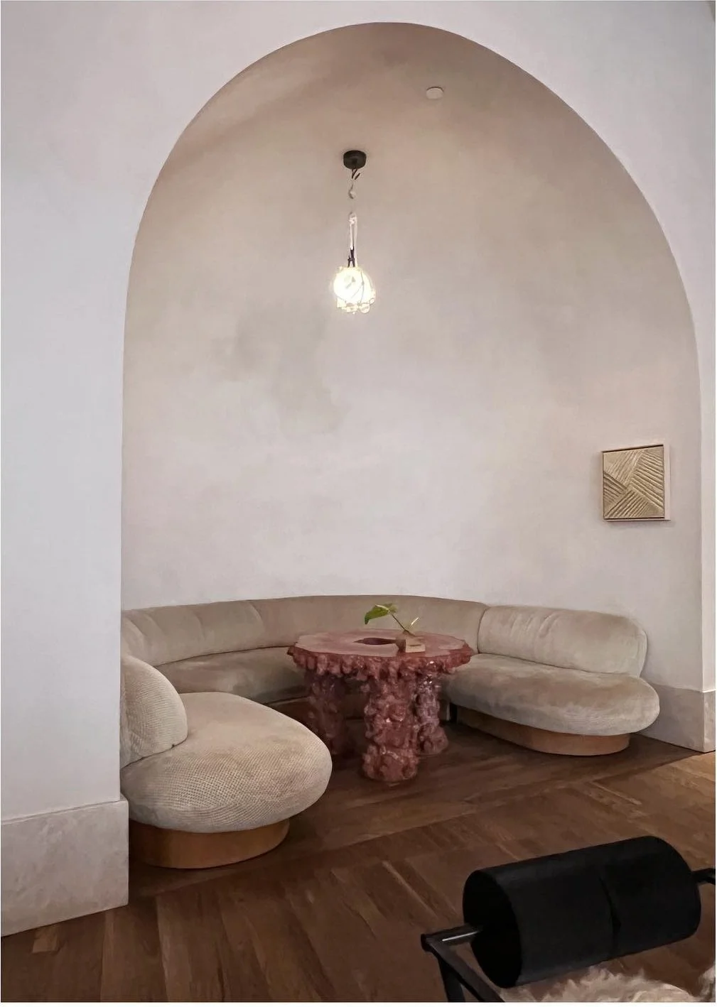 Curved pale seating in a softly lit arched alcove