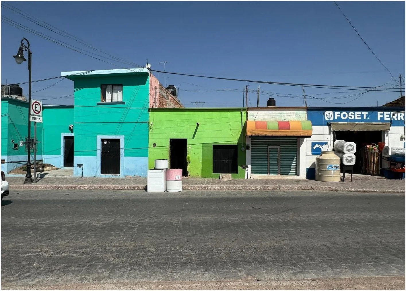 Street of bright green and turquoise low-rise buildings
