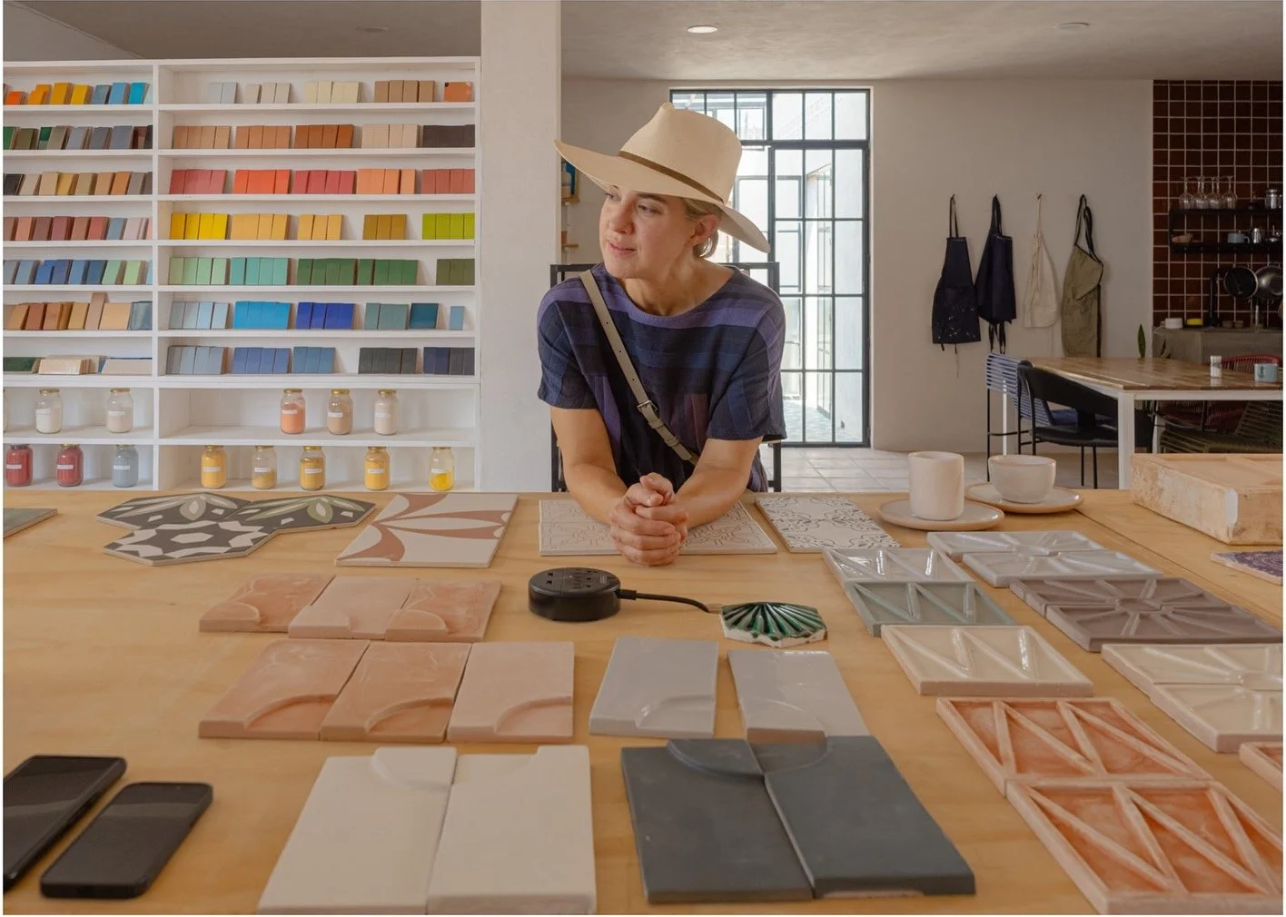 Amy reviewing relief tile samples on a workshop table