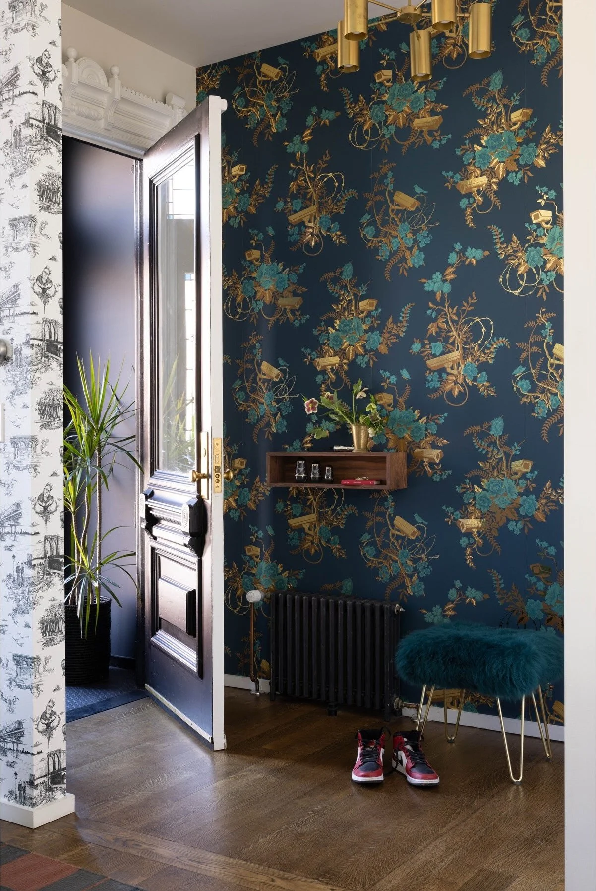 Dark blue botanical wallpaper beside a kitchen doorway
