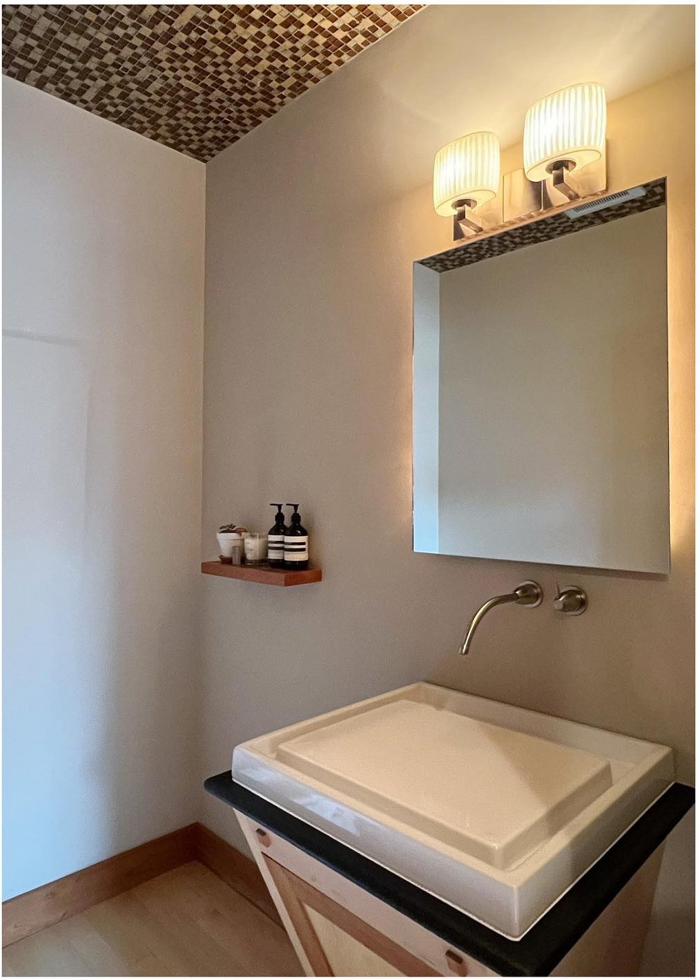 Original small bathroom with pale sink wood vanity and patterned ceiling