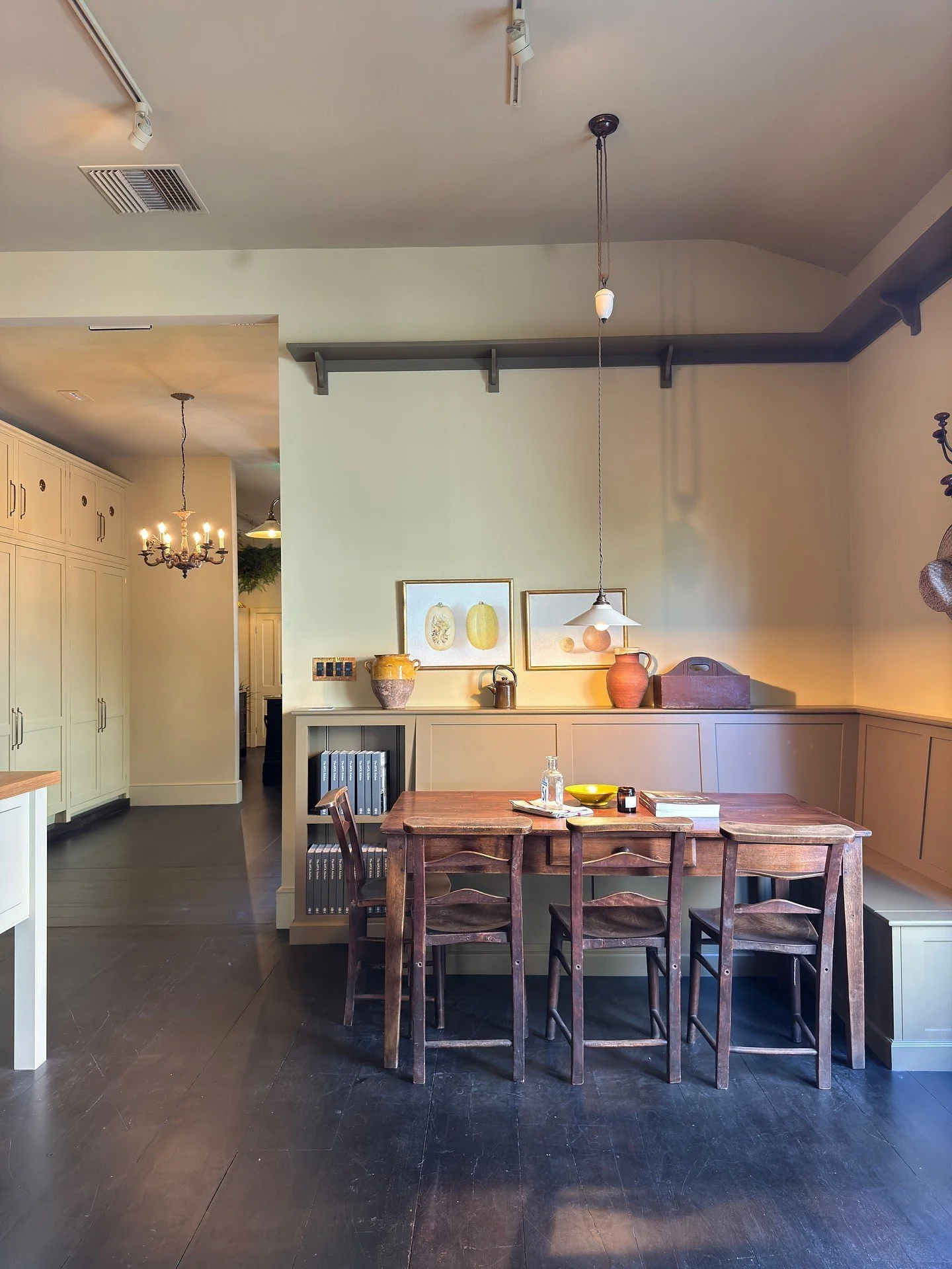 Rustic wood table with stools and a pale tiled wall