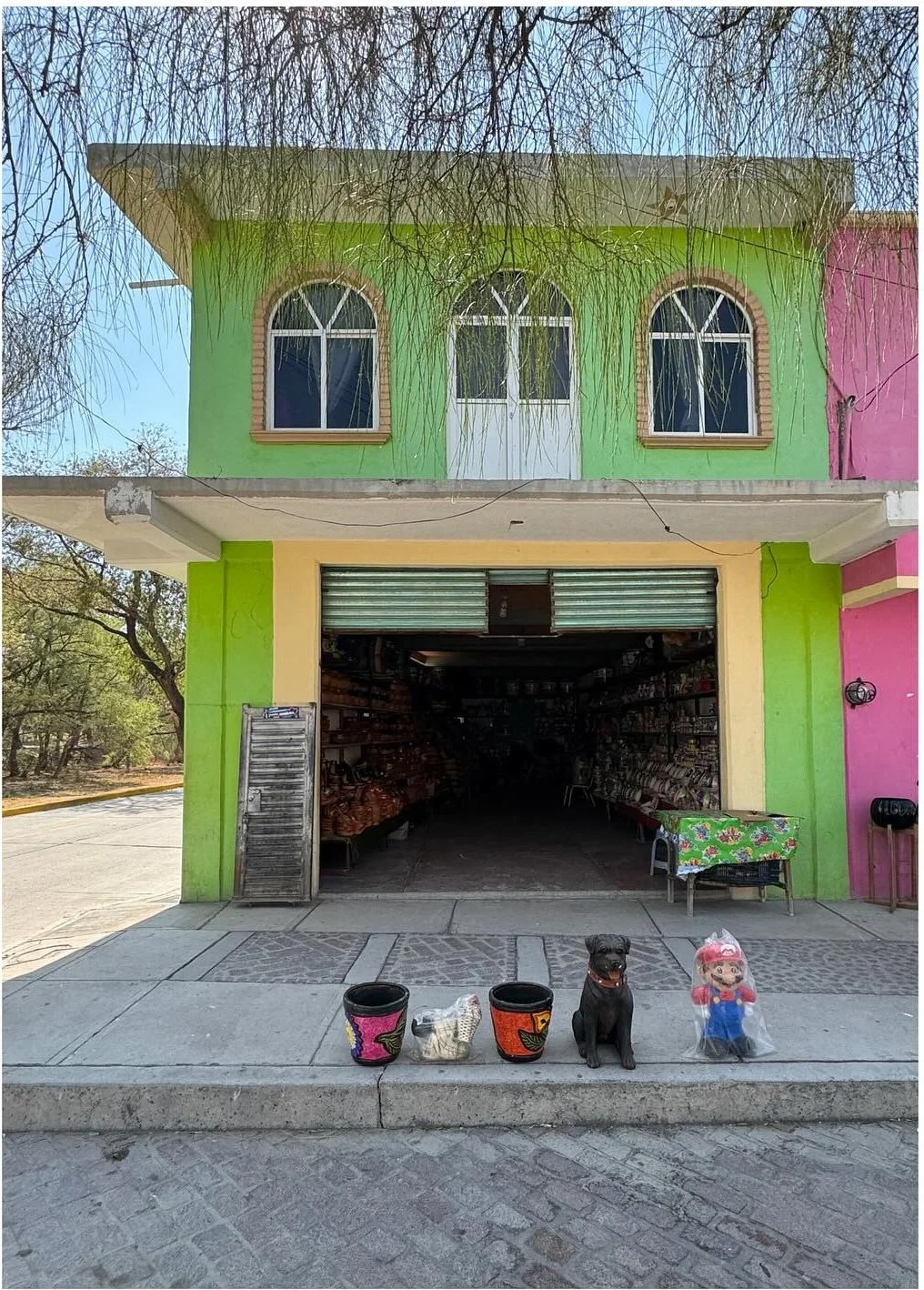 Green and pink building with arched upper windows