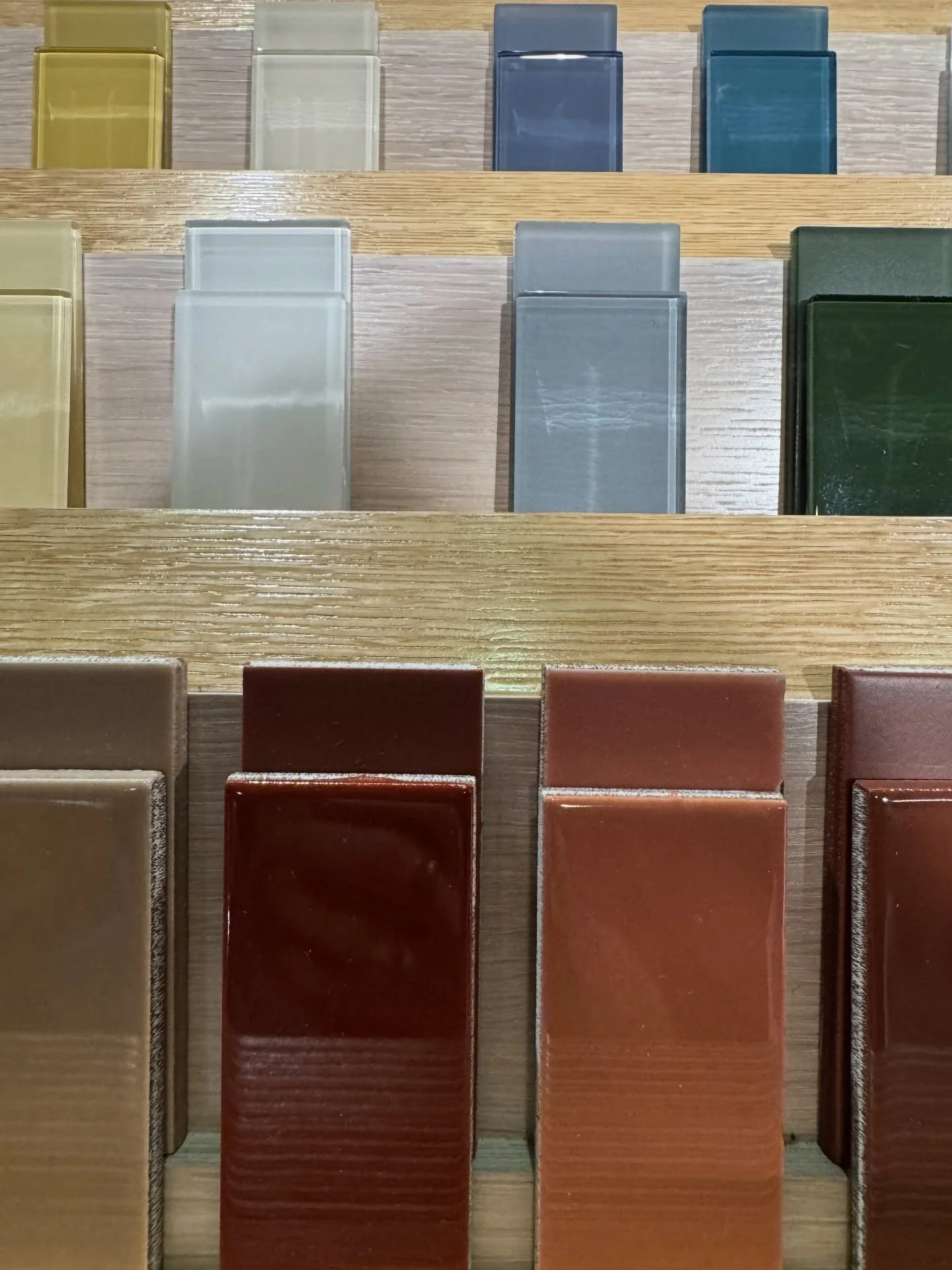 Glossy rectangular tile samples in muted blue brown and green