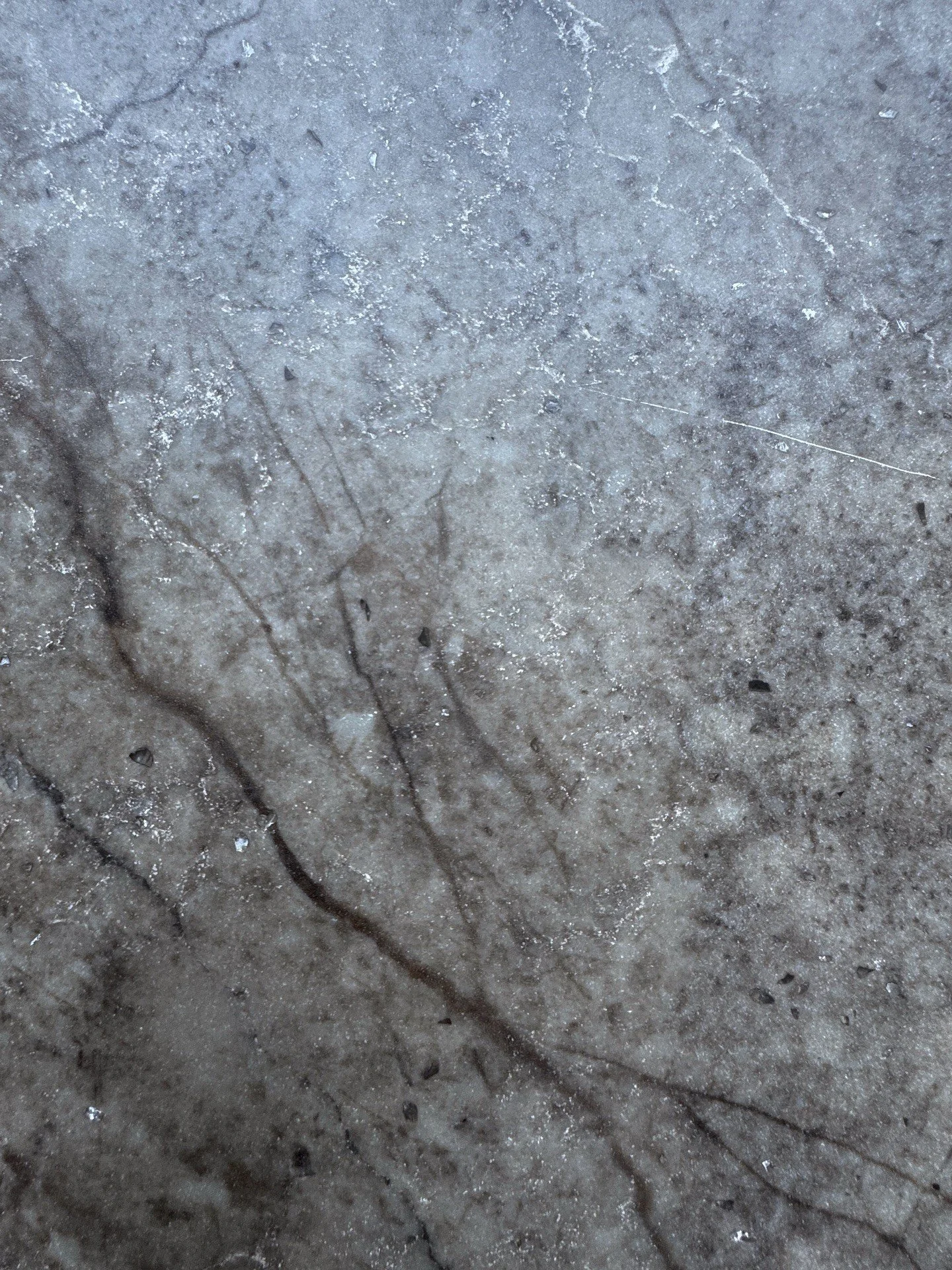 Gray stone surface with dark angular veining