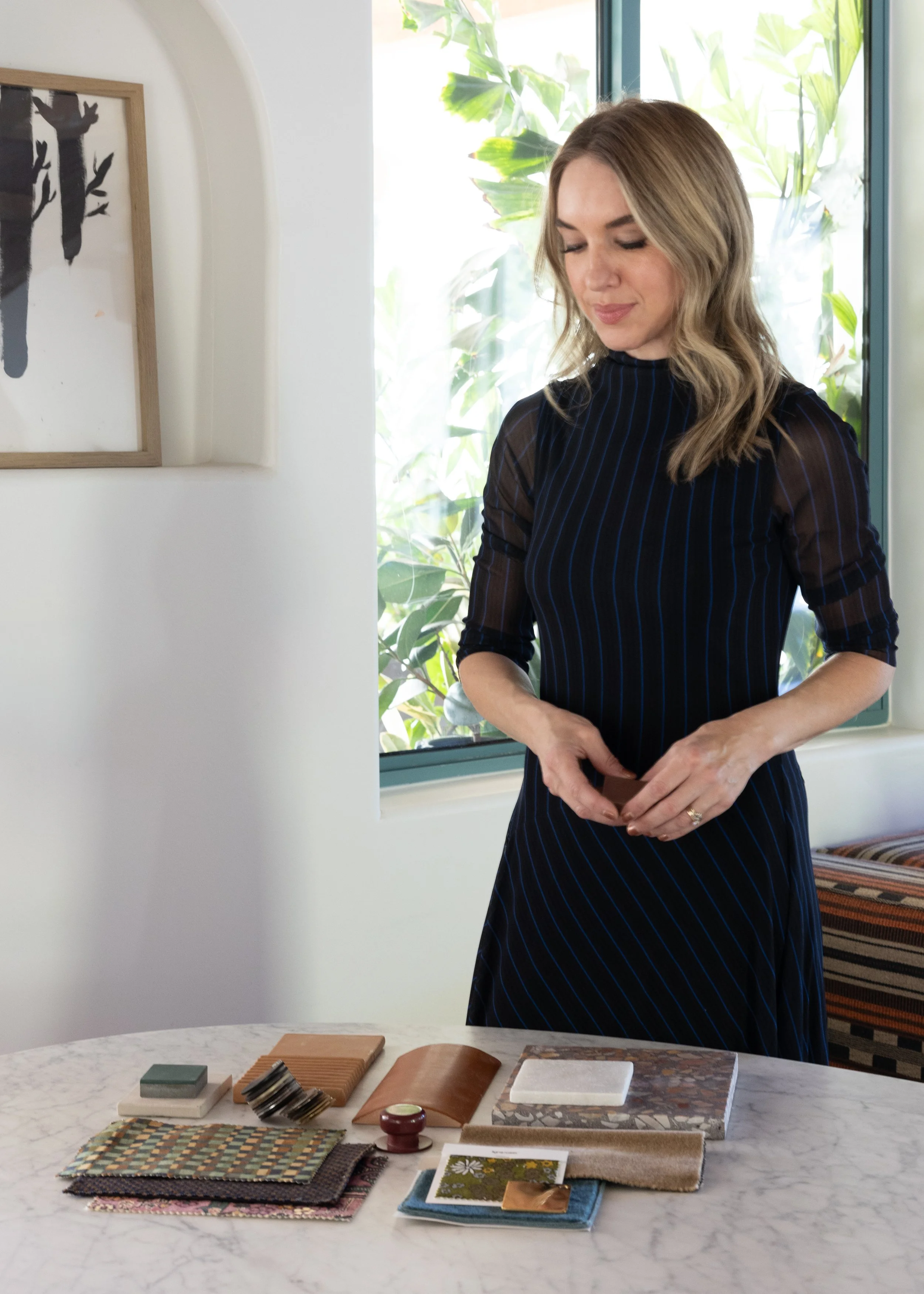 Amy reviewing material samples at a table.