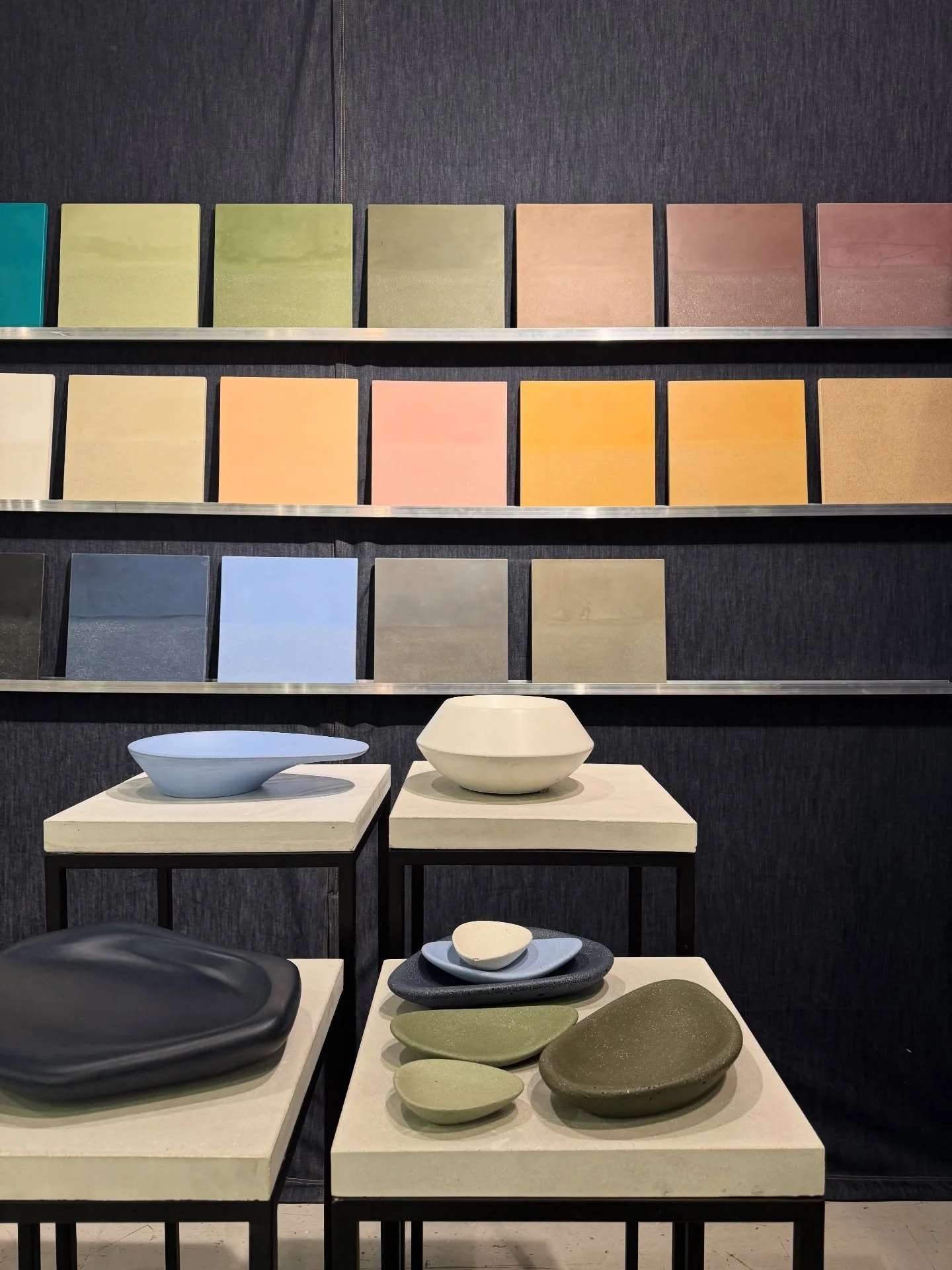 Display of colorful wall finish samples and freestanding basins