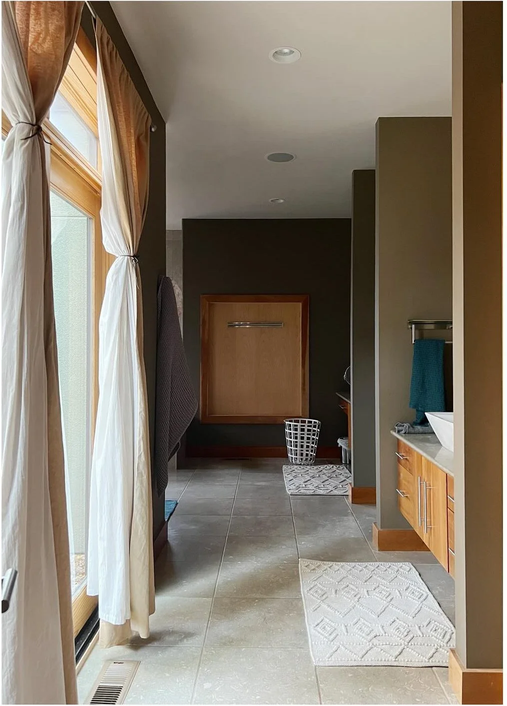 Original bathroom passage with wood doors and a recessed bathtub