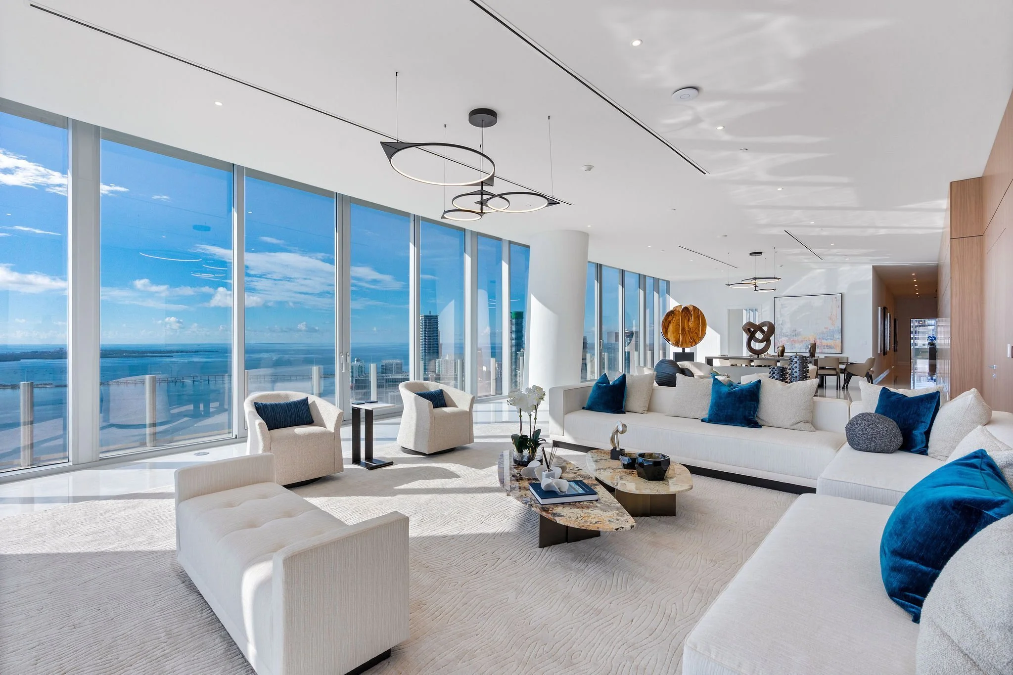 Aston Martin Residences PH6001C main salon and long dining axis toward Biscayne Bay, Miami