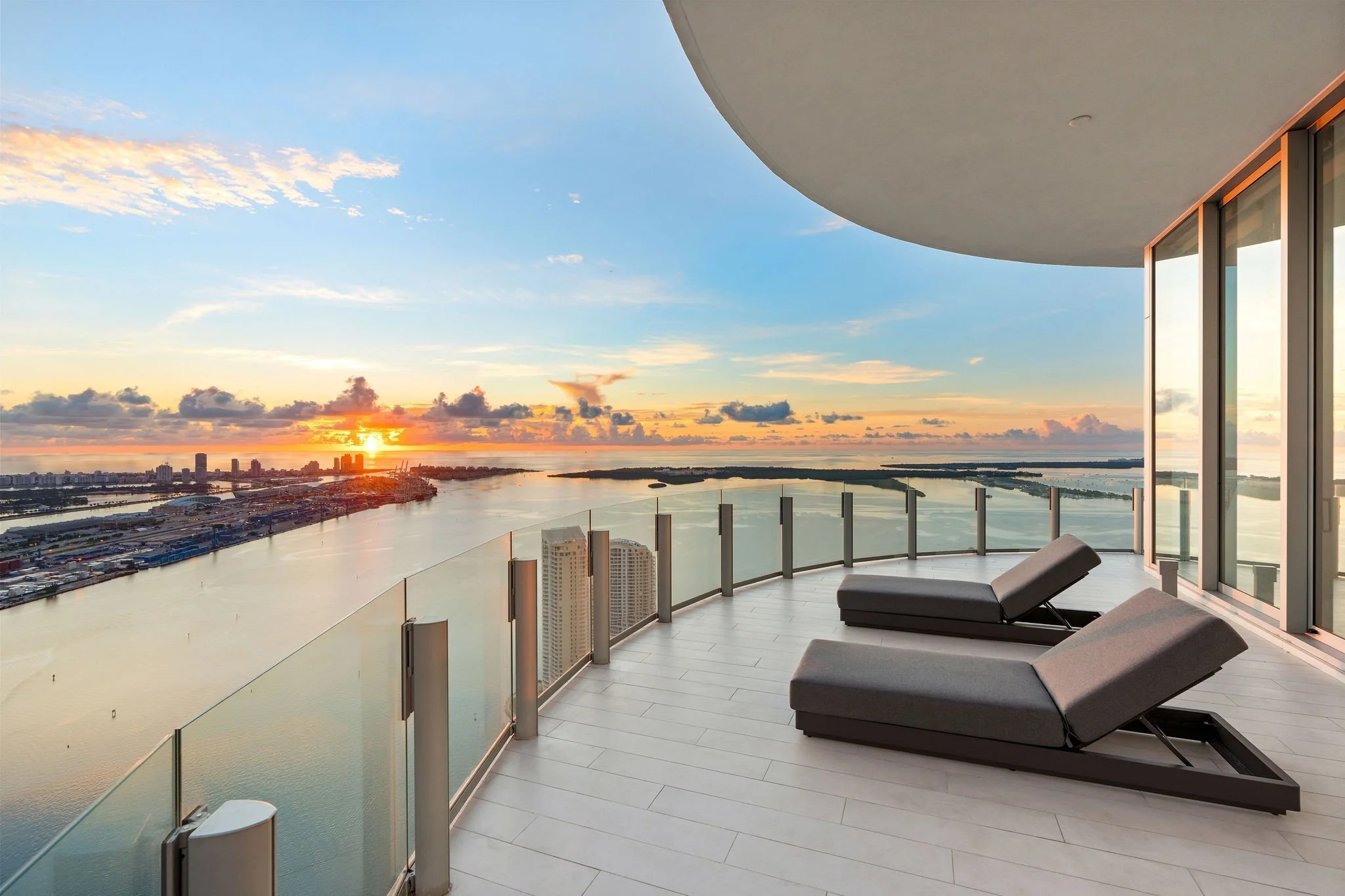 Aston Martin Residences PH6001C furnished terrace loungers at sunrise over Biscayne Bay, Miami