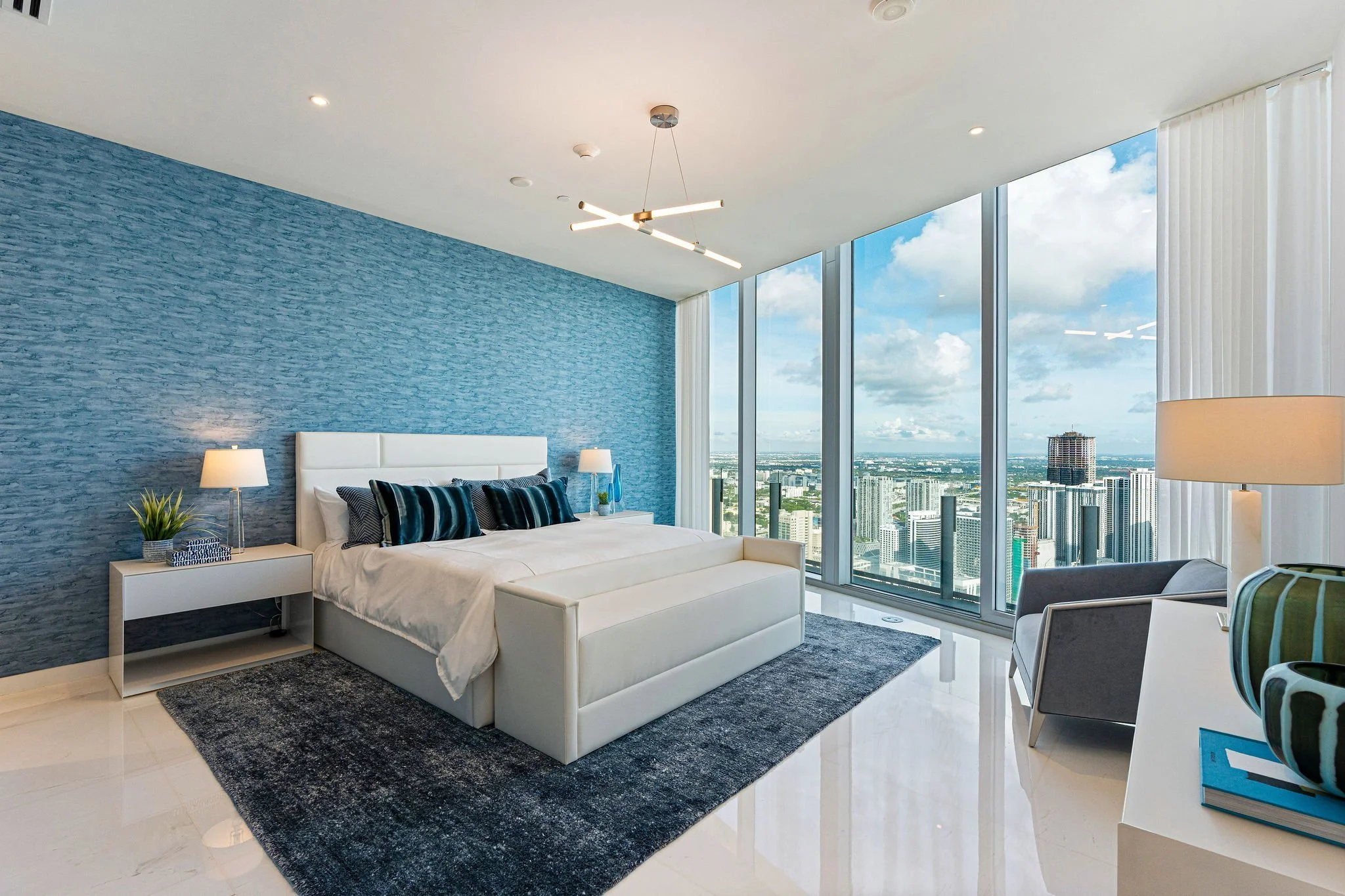 Aston Martin Residences PH6001C bedroom with blue accent wall and city views, Miami