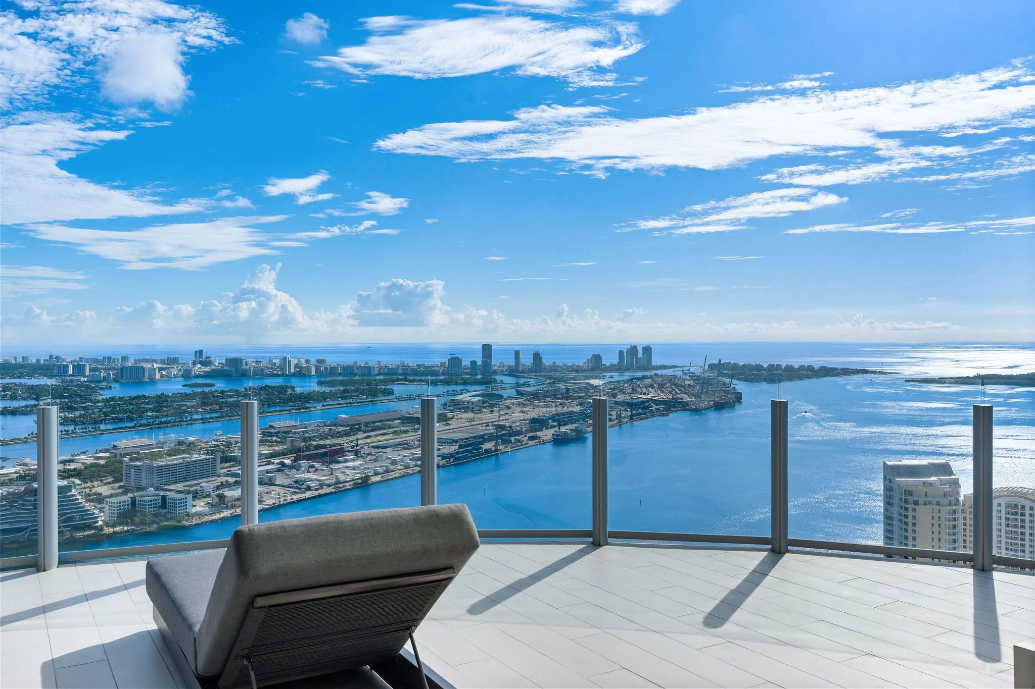37-aston-martin-residences-ph6001c-terrace-chaise-and-wide-daytime-bay.jpg
