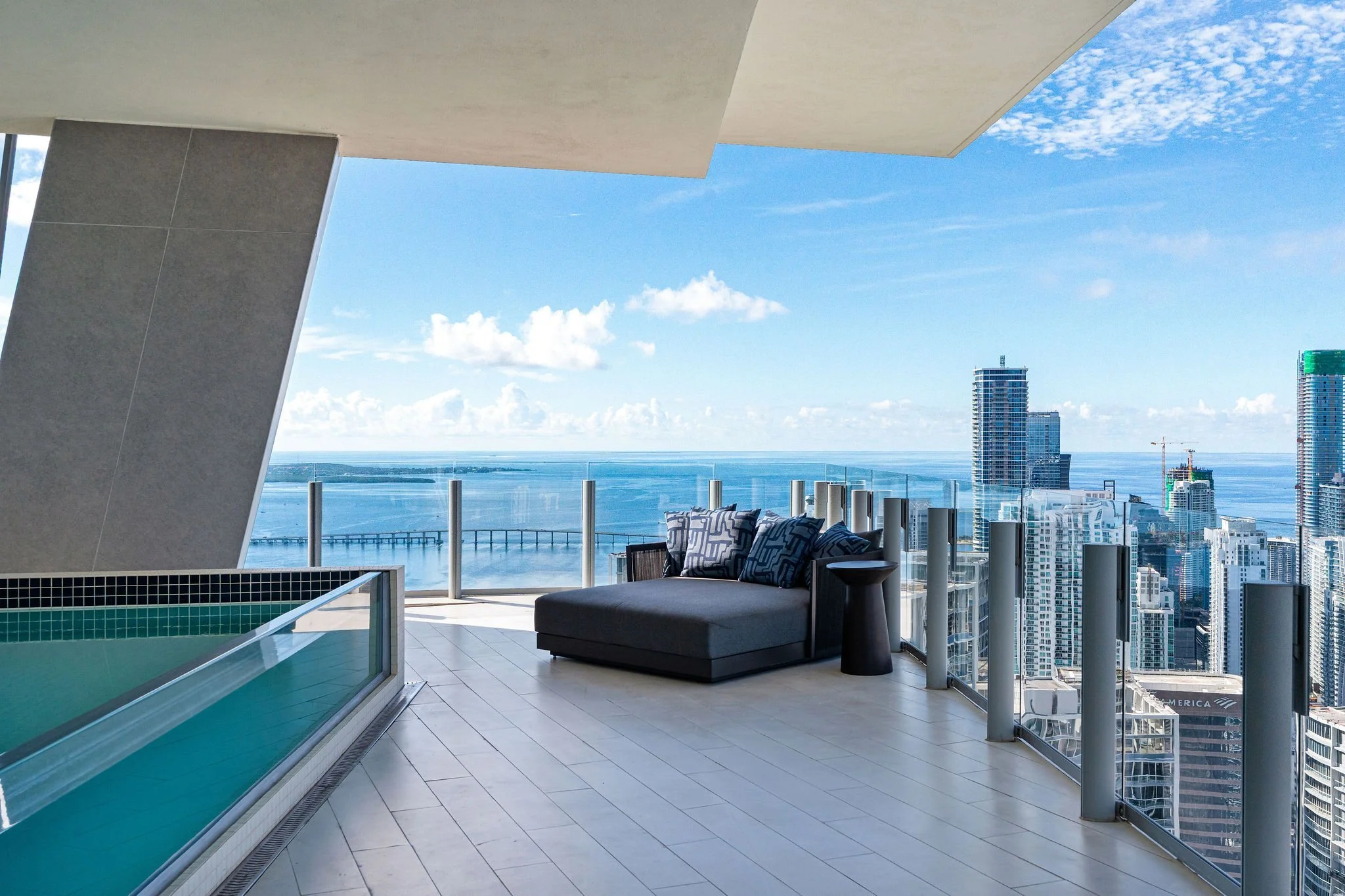 Aston Martin Residences PH6001C poolside chaise with open Biscayne Bay view, Miami