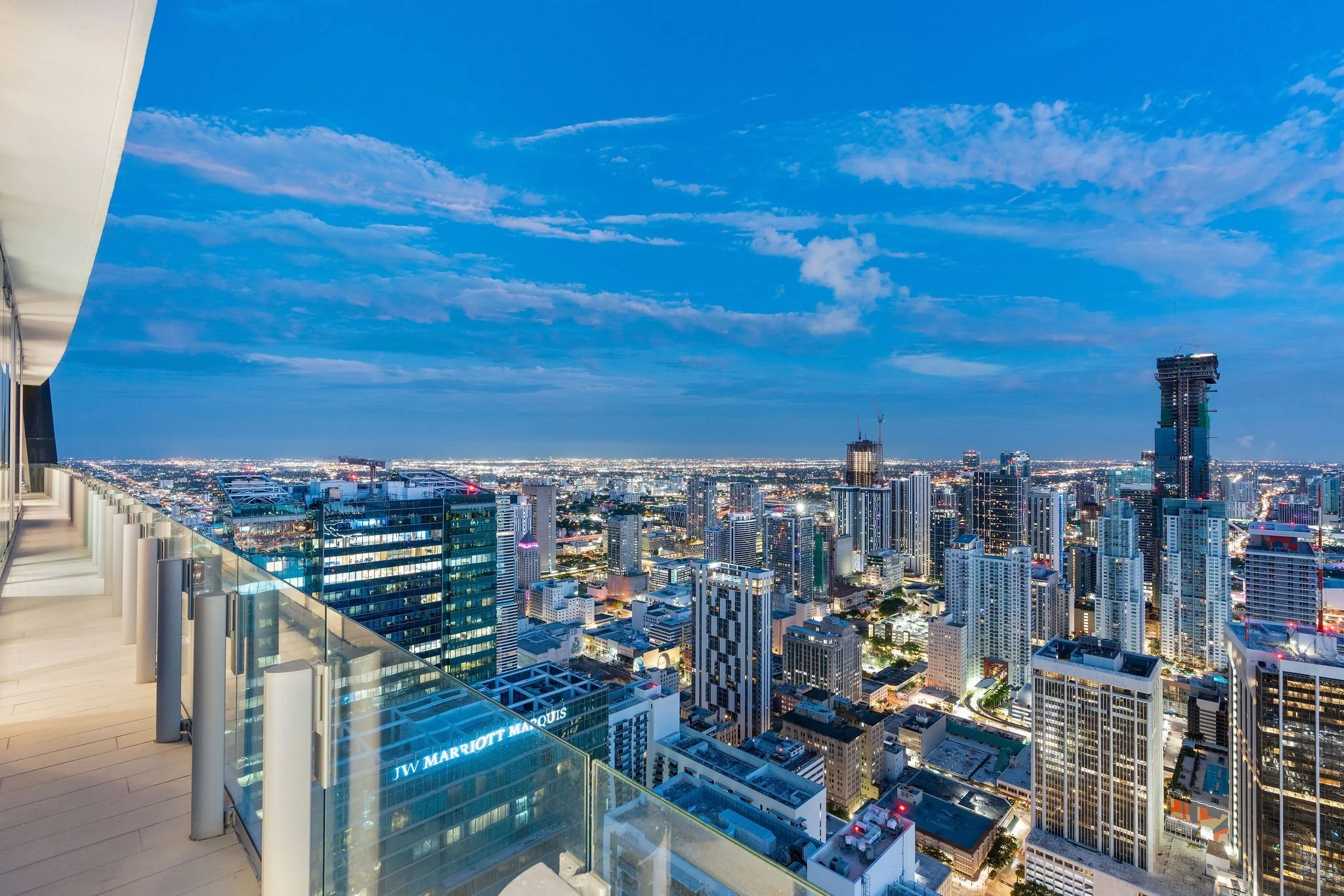 Aston Martin Residences PH6001C wide terrace view of the illuminated Miami skyline at dusk, Miami