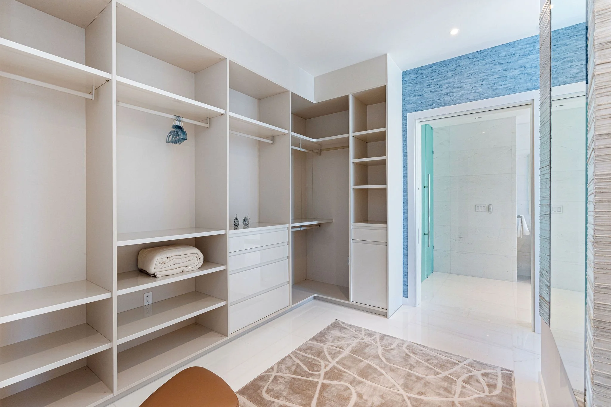 34-aston-martin-residences-ph6001c-fitted-closet-with-blue-wall.jpg