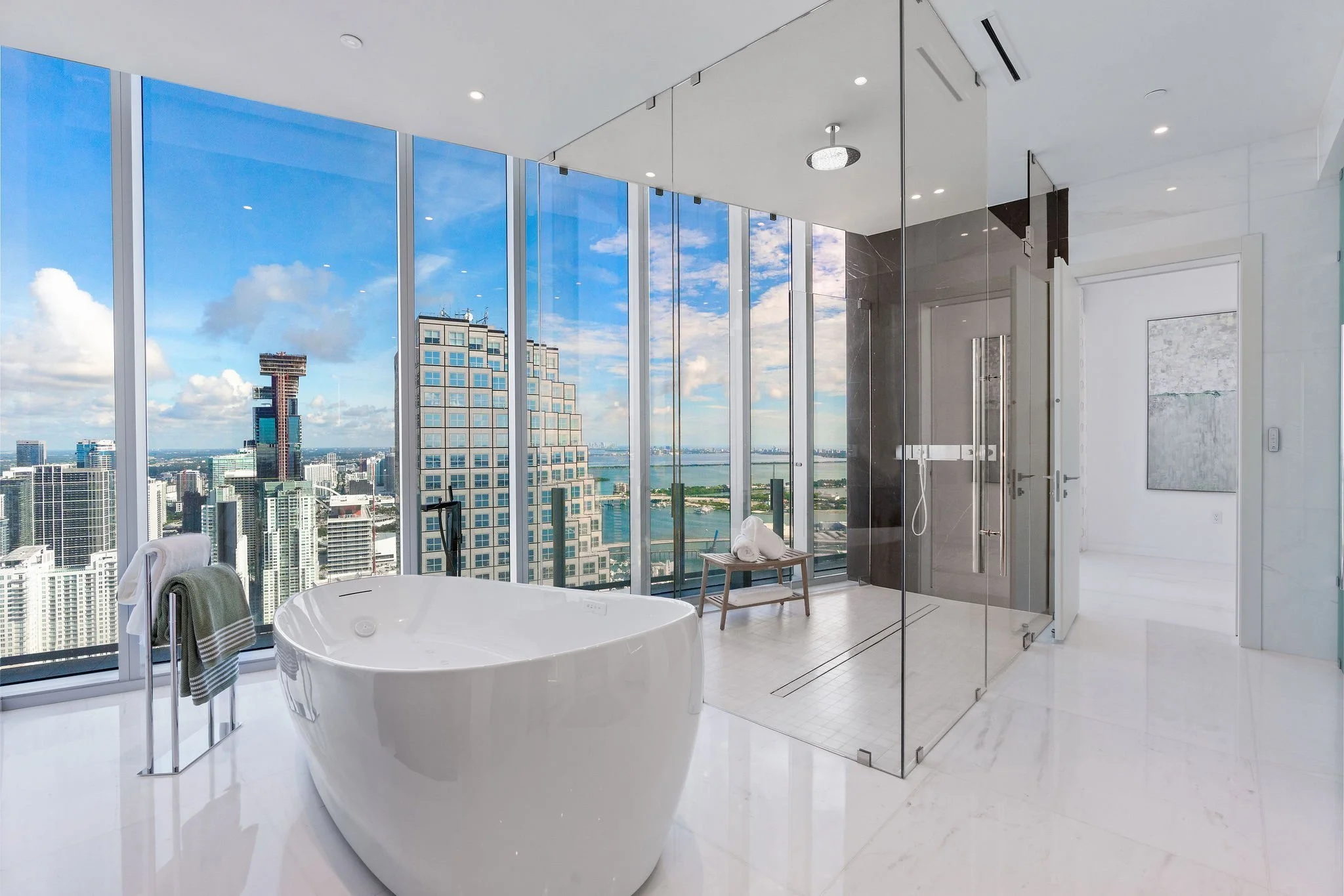 Aston Martin Residences PH6001C primary bath freestanding tub and glass shower with skyline view, Miami
