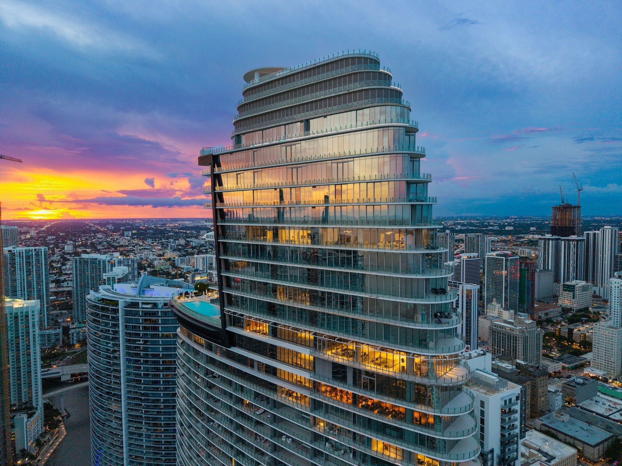 Aston Martin Residences PH6001C tower exterior at twilight above Biscayne Bay, Miami