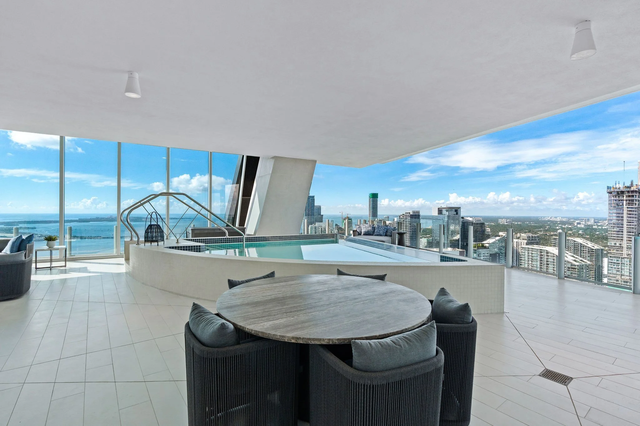 Aston Martin Residences PH6001C covered outdoor dining and private pool with daytime skyline, Miami