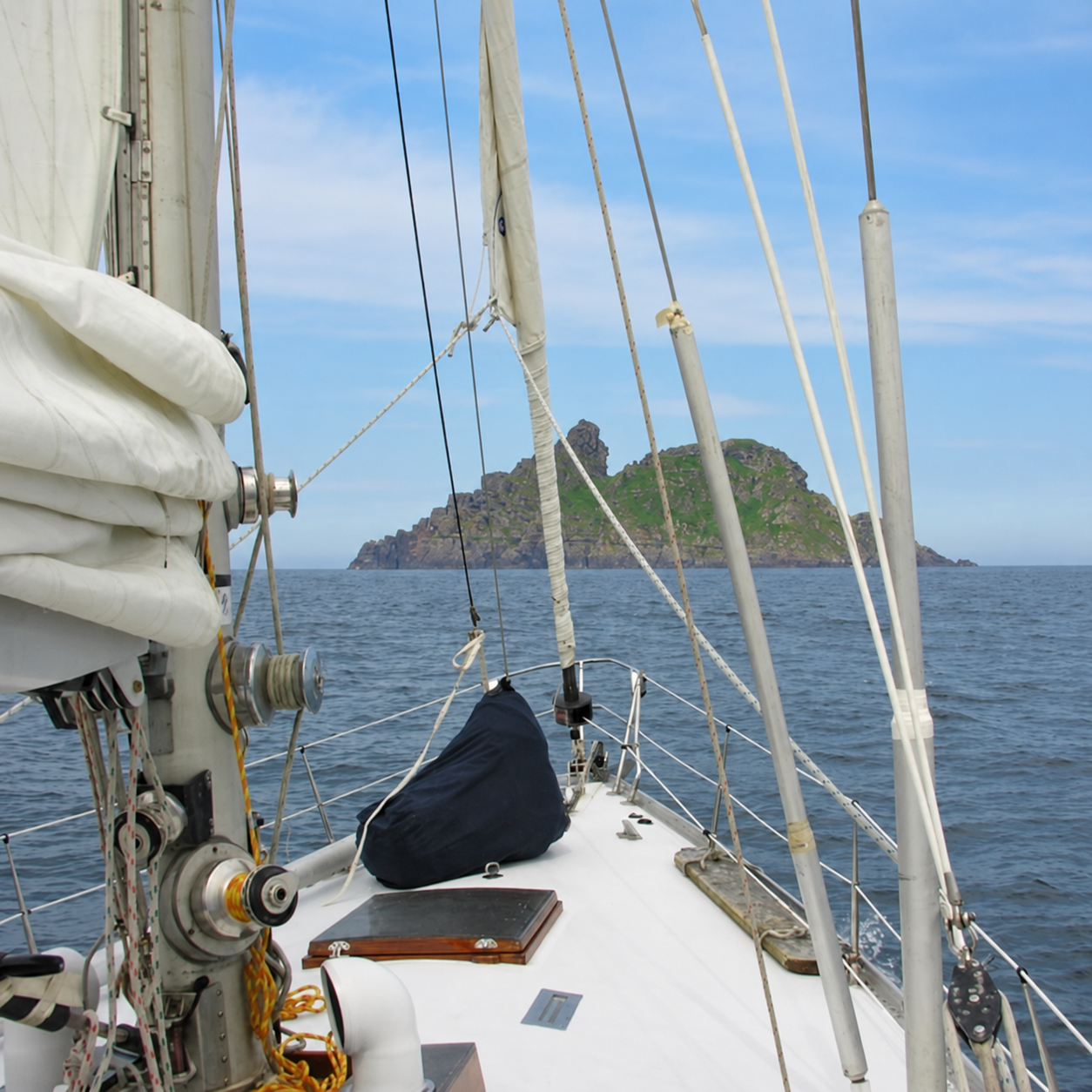 Sailing toward Skellig Michael off the coast of Ireland, seen from the bow of a sailboat