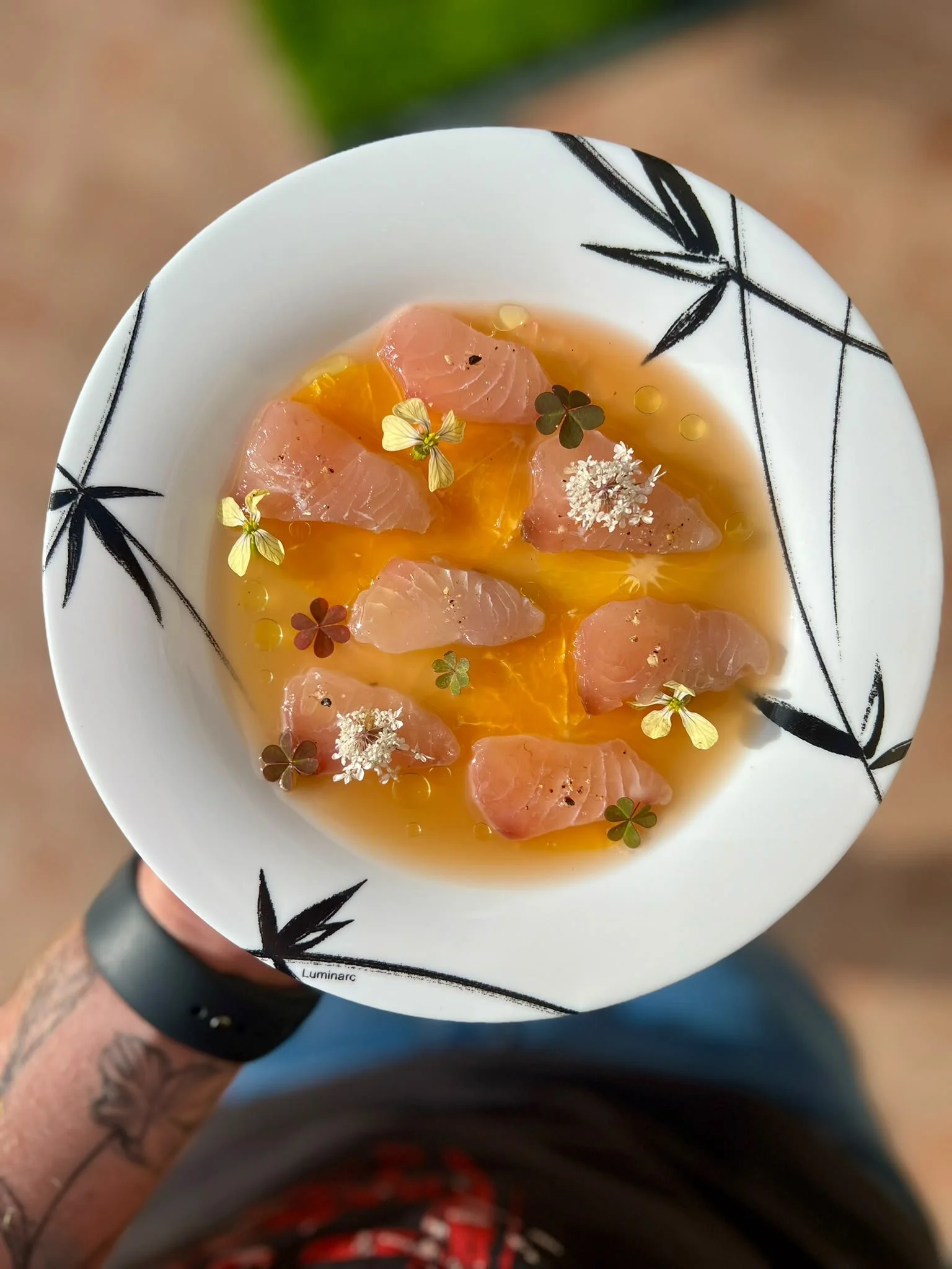 Citrus crudo with edible flowers, prepared by Limonit Hospitality