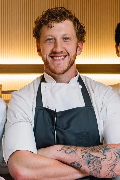 Portrait of the Limonit chef in a white jacket and dark apron
