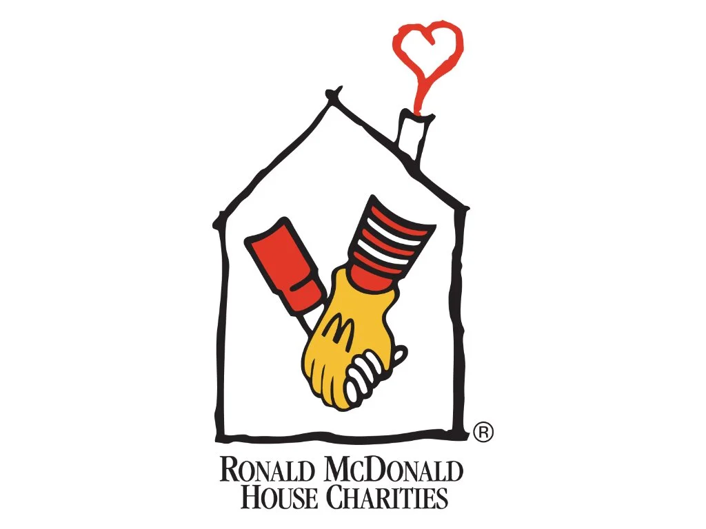 Ronald McDonald House Charities logo showing two gloved hands shaking inside a house outline with a red heart chimney.
