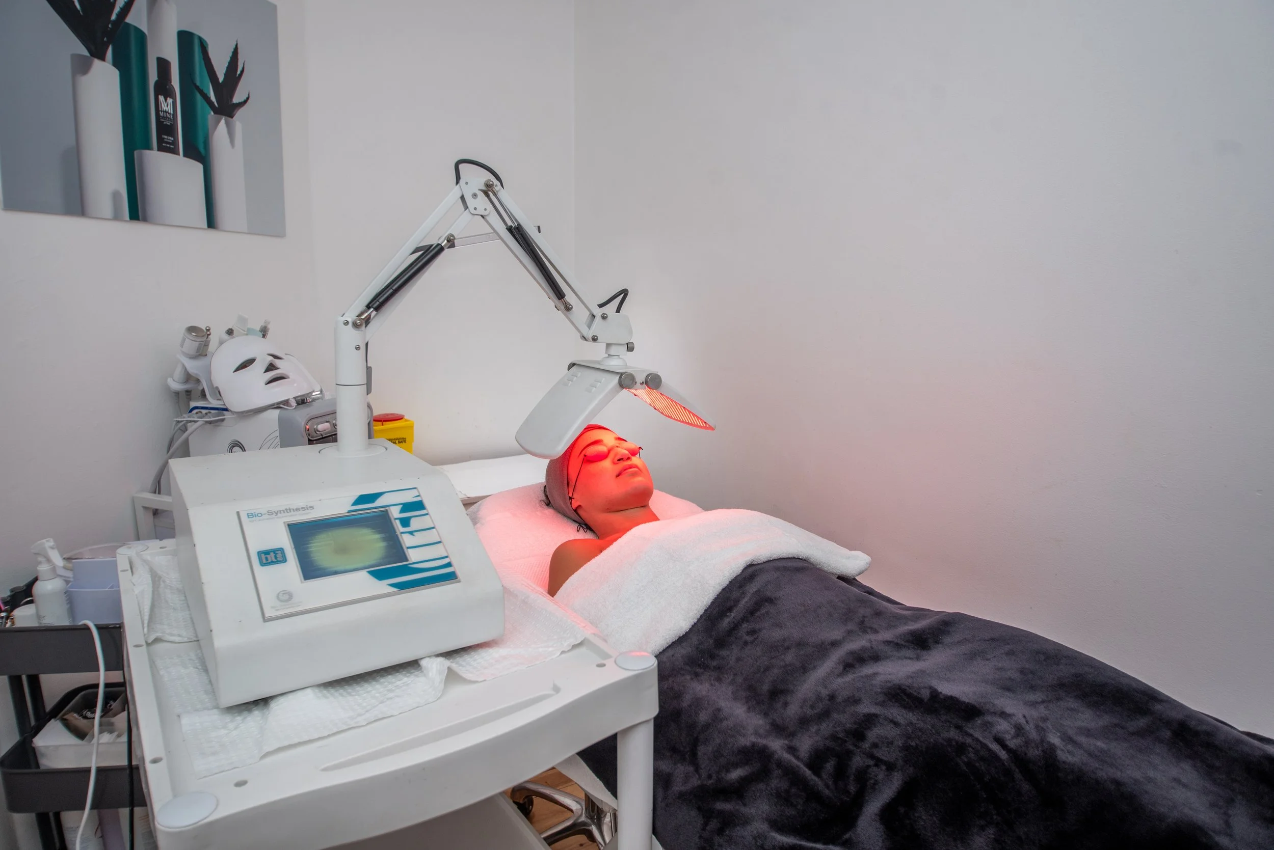 Client relaxing during an LED light therapy facial at Ivy Skin Padstow Heights