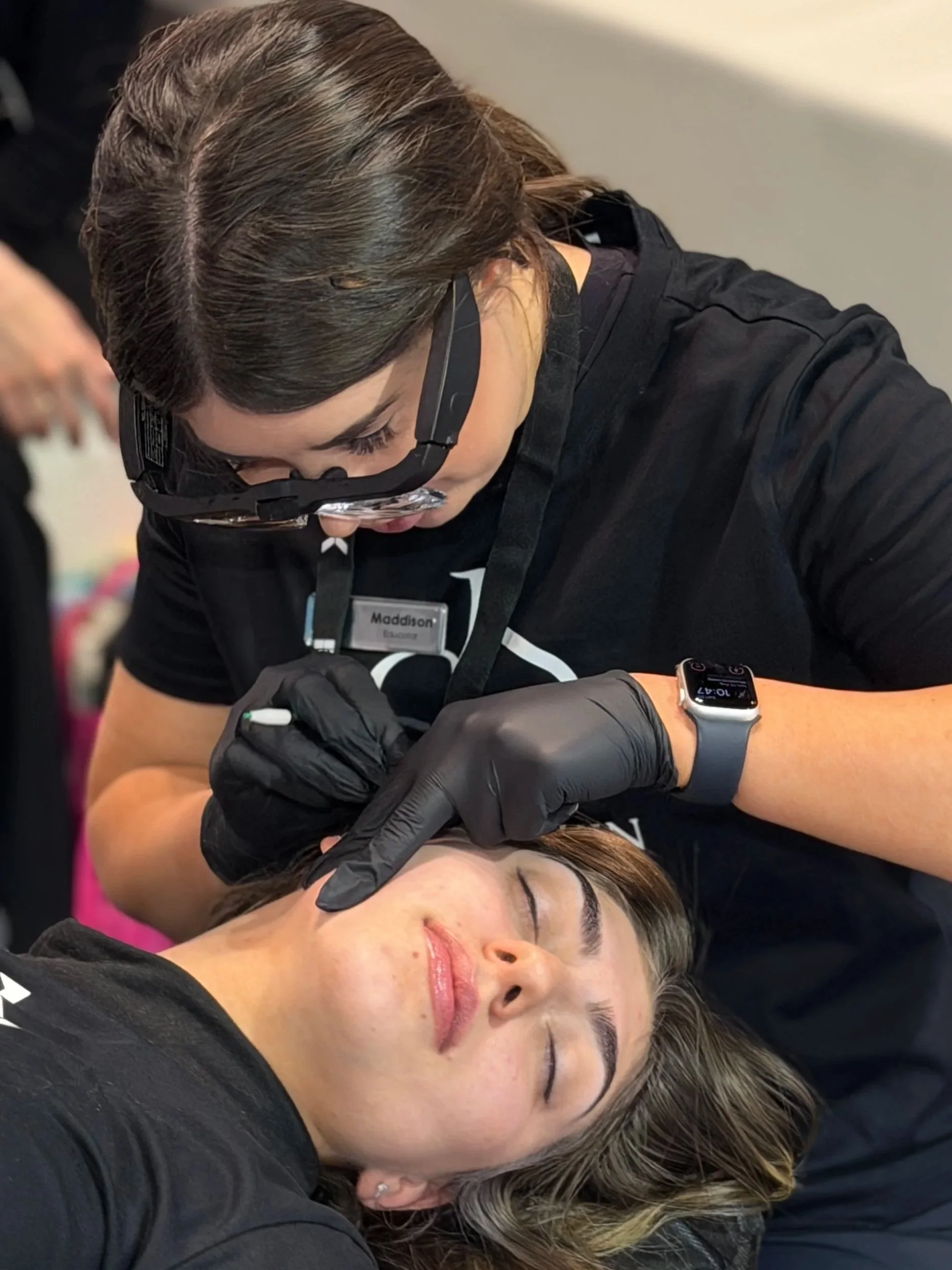 Ivy Skin therapist wearing magnifying loupes performing facial electrolysis on a client