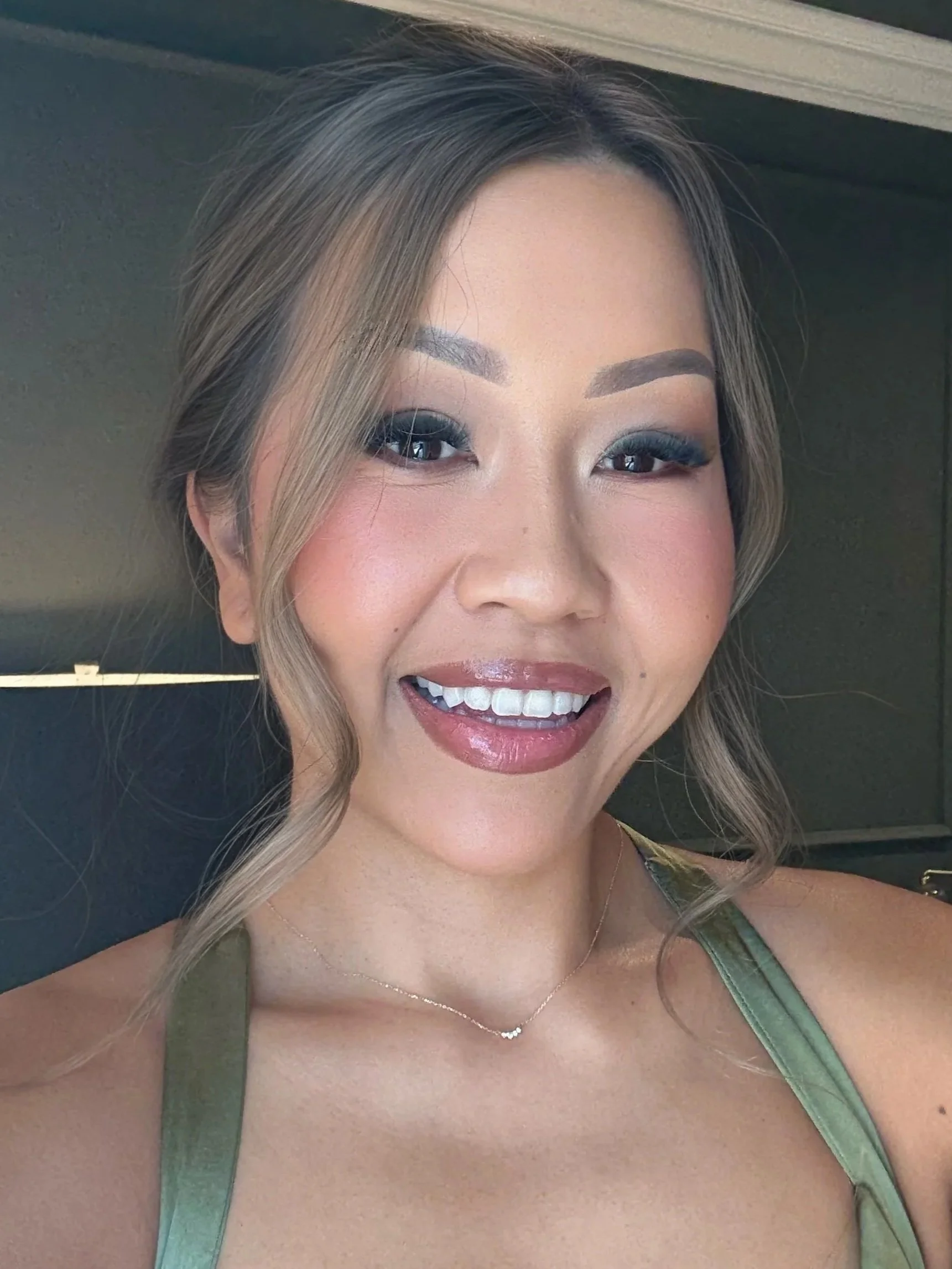 Nikki Son Huang, Los Angeles UGC creator, smiling in a green satin top