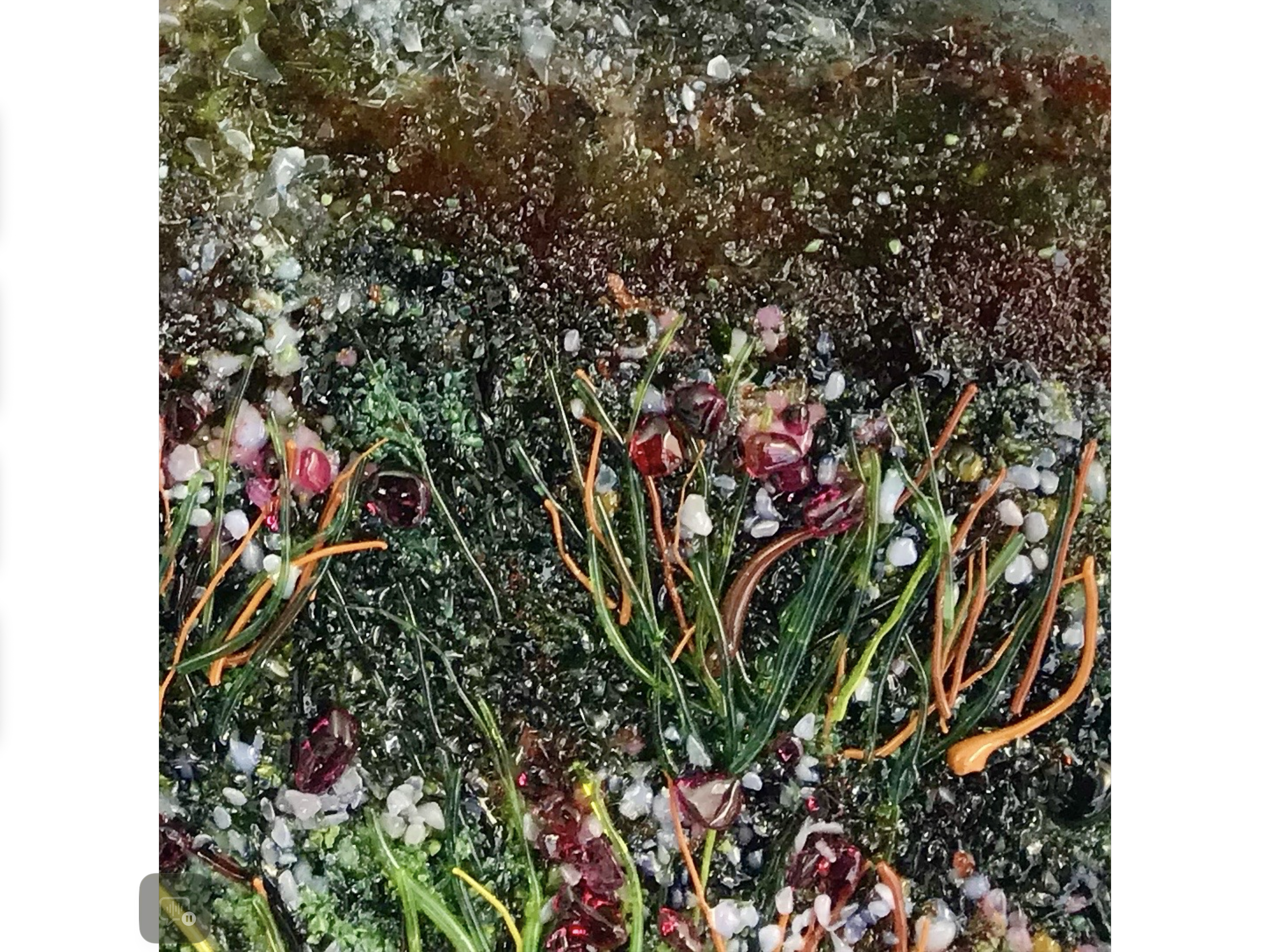 Close-up of colorful shredded plastic and glitter-like debris mixed with green and orange strands