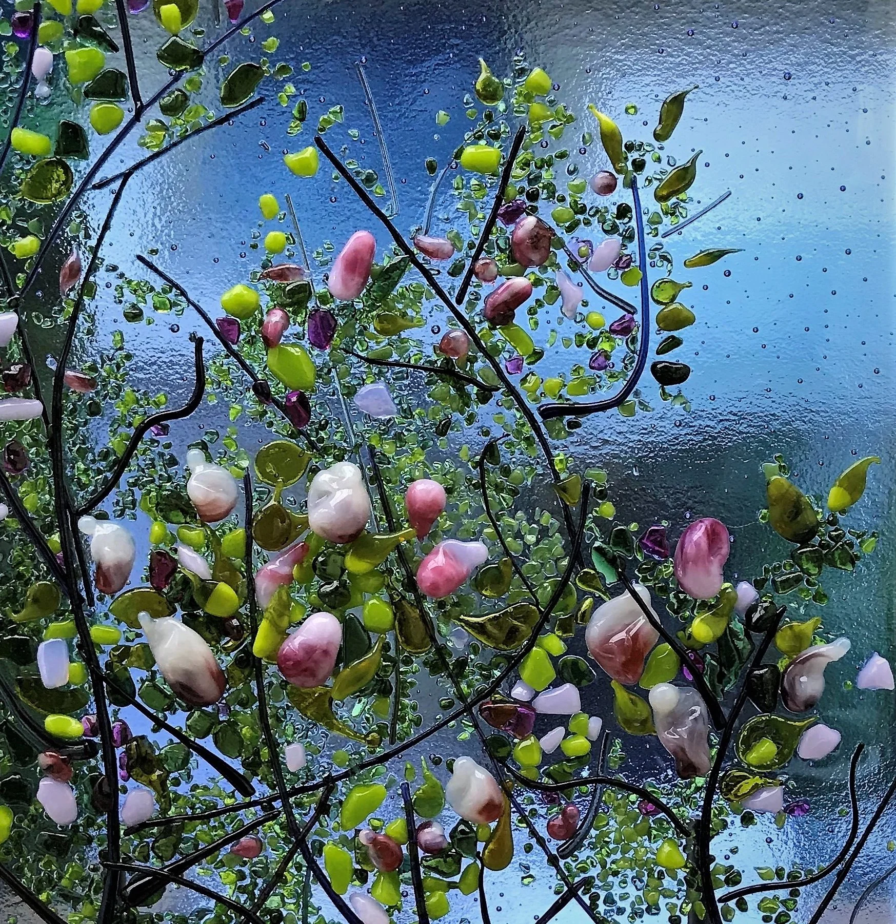 Magnolias - Abstract mosaic of colourful glass fragments and black wire shapes on a blue textured background